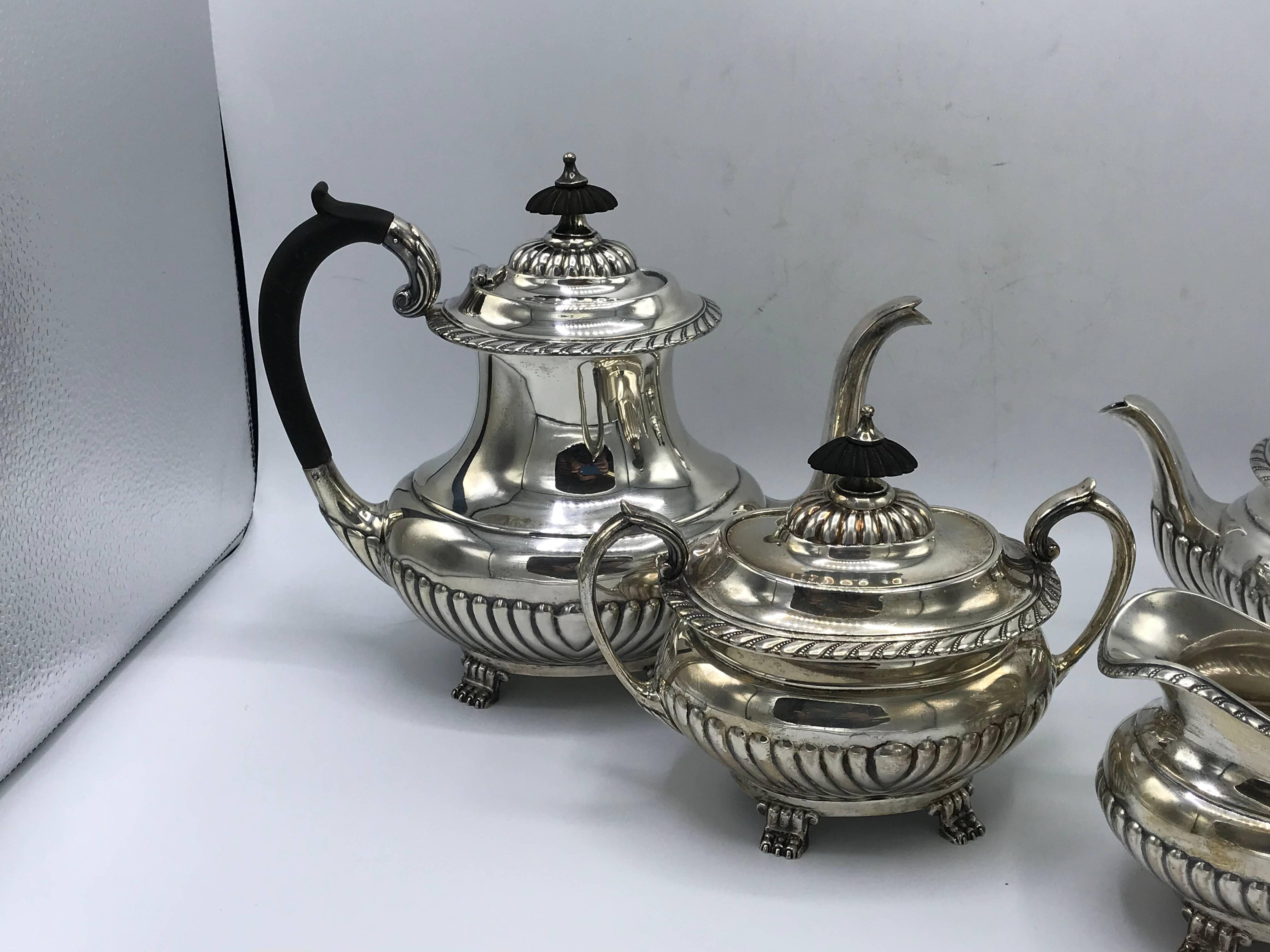Offered is an exquisite, set of four, 1940s Reed & Barton Stratford sterling silver coffee or tea set. Set includes: coffee pot with a hinged lid and wood knob/handle, tea pot with a hinged lid and wood knob/handle, sugar bowl with removable lid
