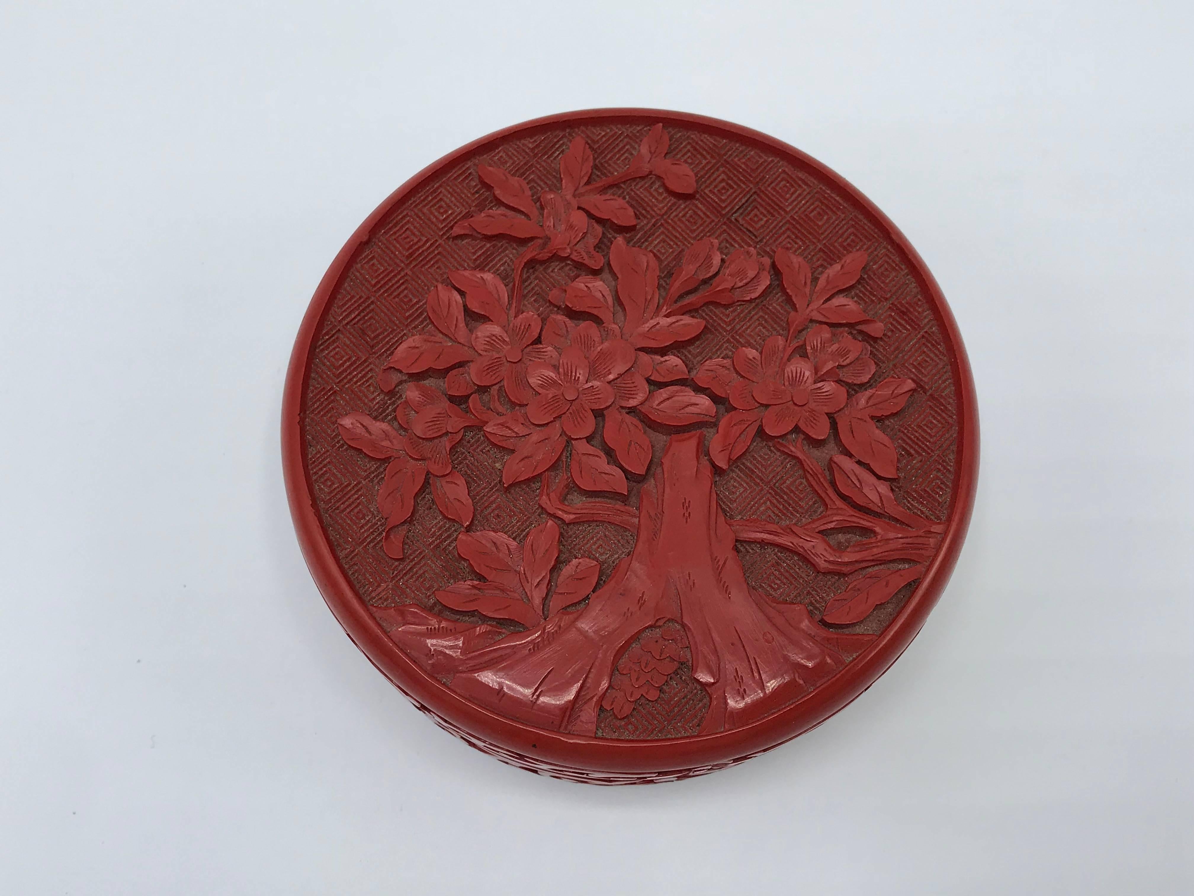 Offered is an exquisite, 1960s cinnabar and cloisonné lidded box. The piece has a heavily details floral and tree motif on the lid with ornate fretwork around the sides.