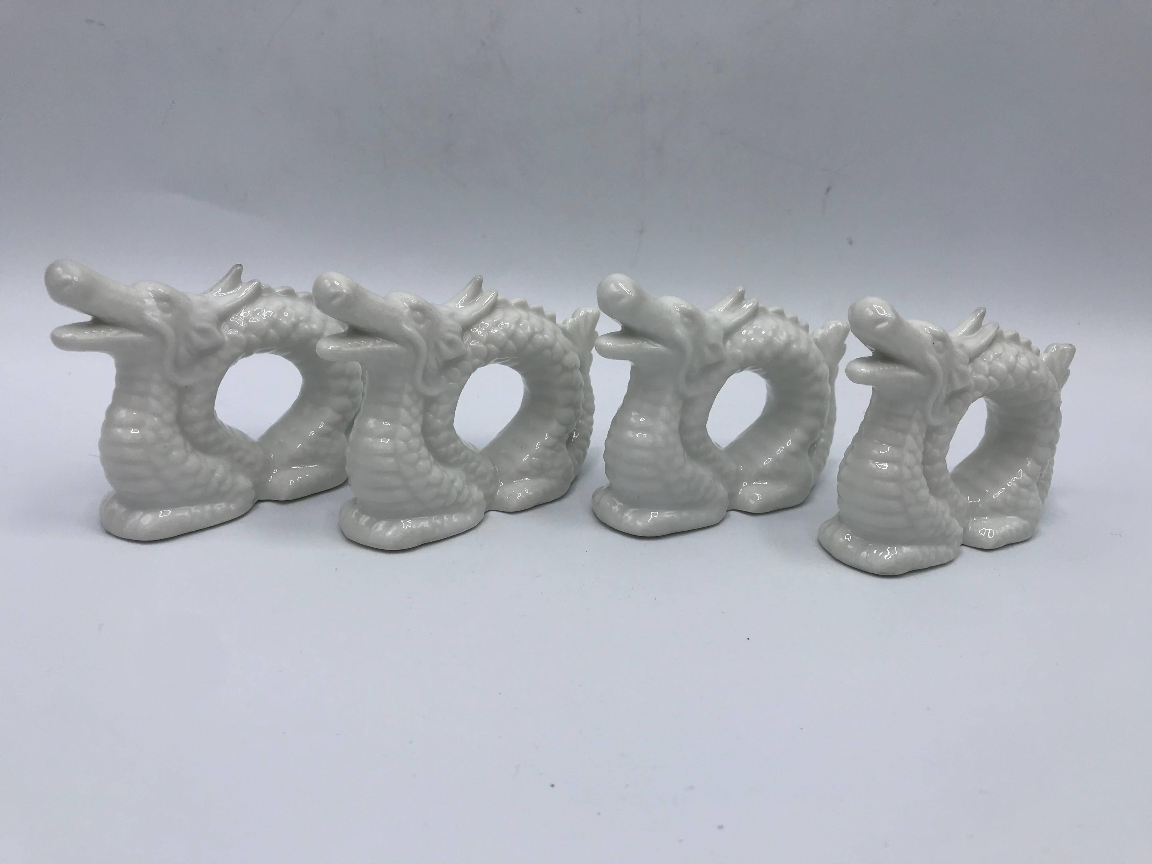 Offered is a beautiful, set of four, 1960s Blanc de Chine porcelain dragon sculpture napkin rings.
