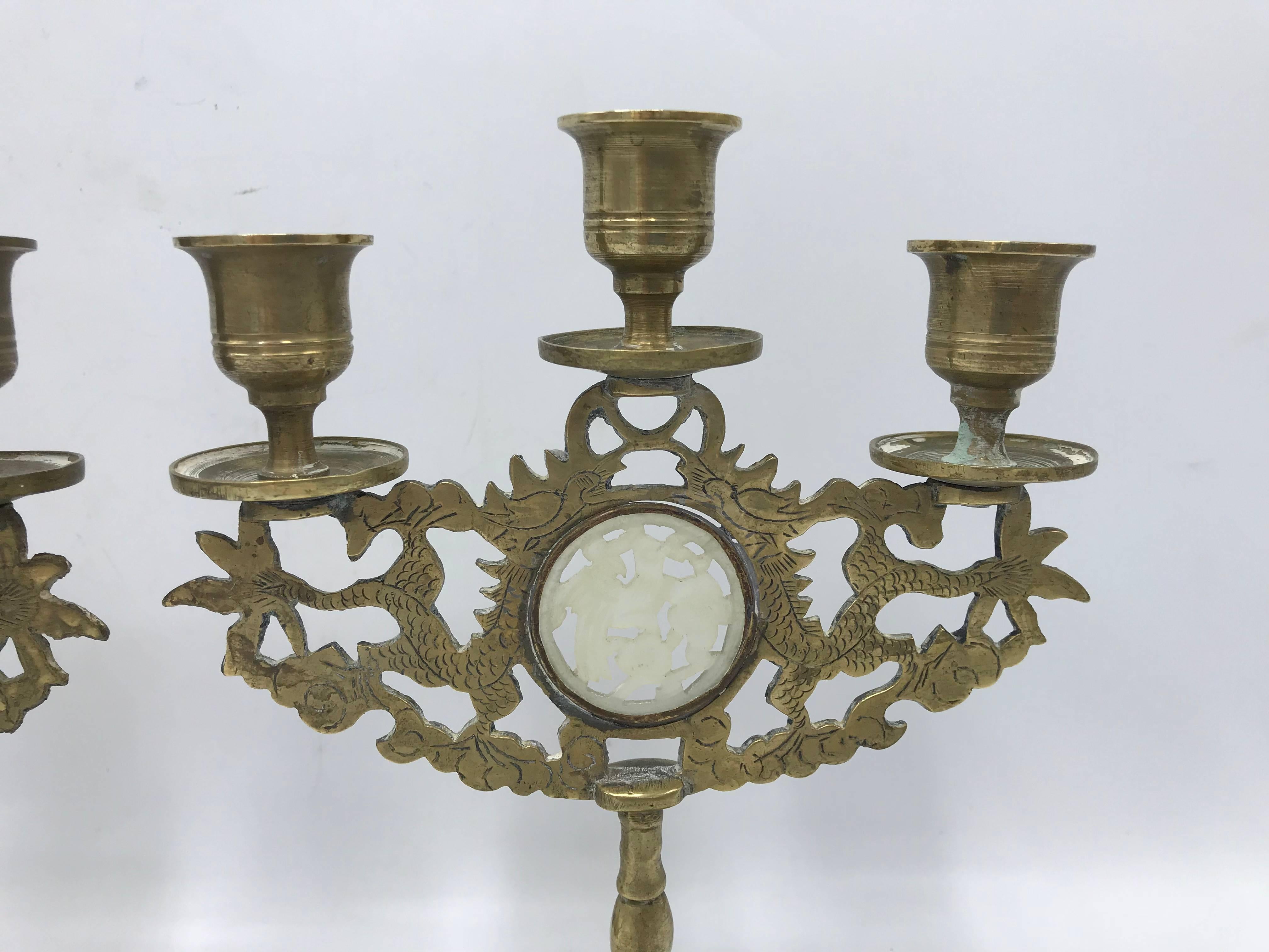 Offered is a gorgeous, pair of 1960s Asian brass three-arm candelabra candlestick holders. Each has a dragon motif with a jade insert. Marked 'China' on underside.