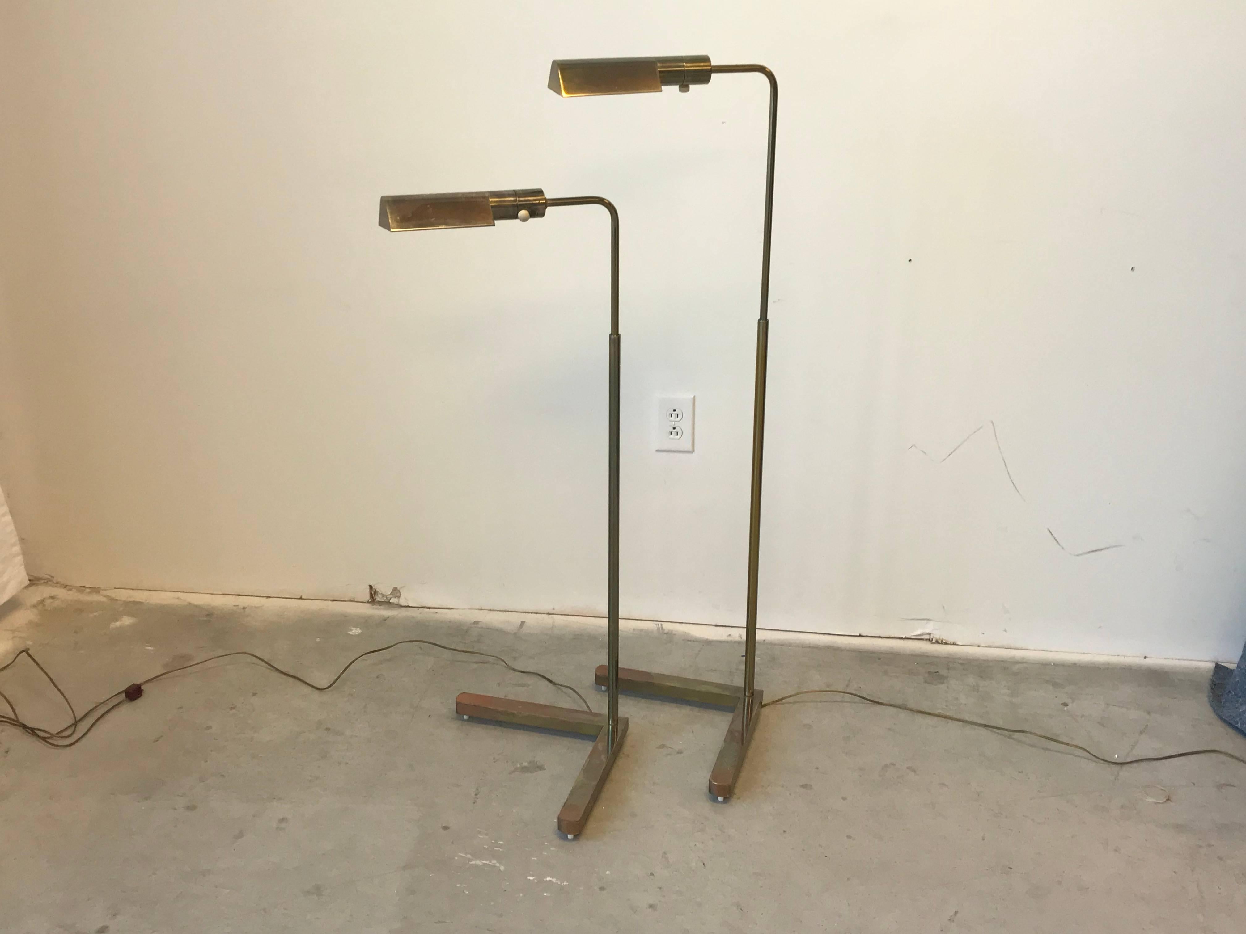 Offered is a stunning, pair of 1970s Casella swivel floor lamps with V-shaped bases. The pair have a brass-bronze finish. Manufactured in San Francisco, California, USA. Each lamp includes the original tag on underside of base. Measure: Minimum