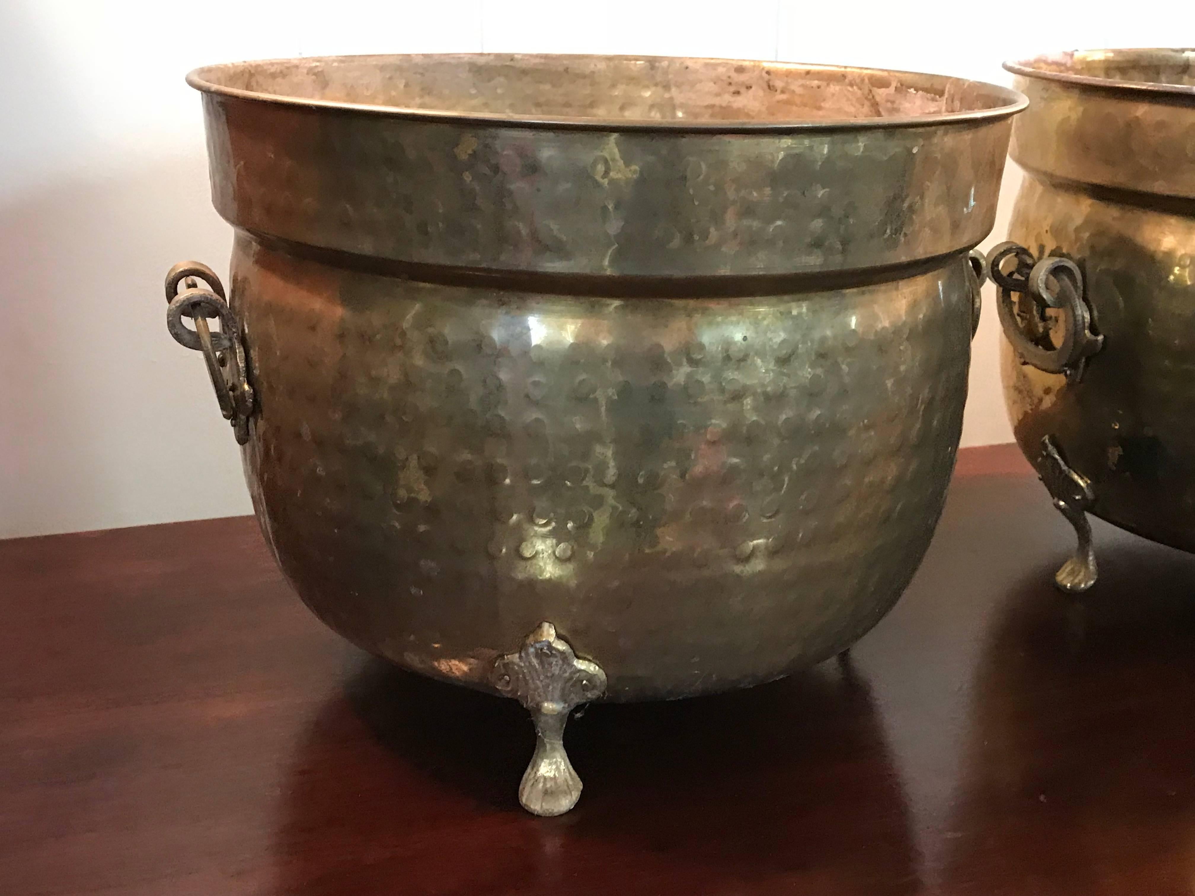 Offered is a fabulous, pair of large, 1960s Italian hammered brass cachepot planters. Each has three clawfeet and two handles.