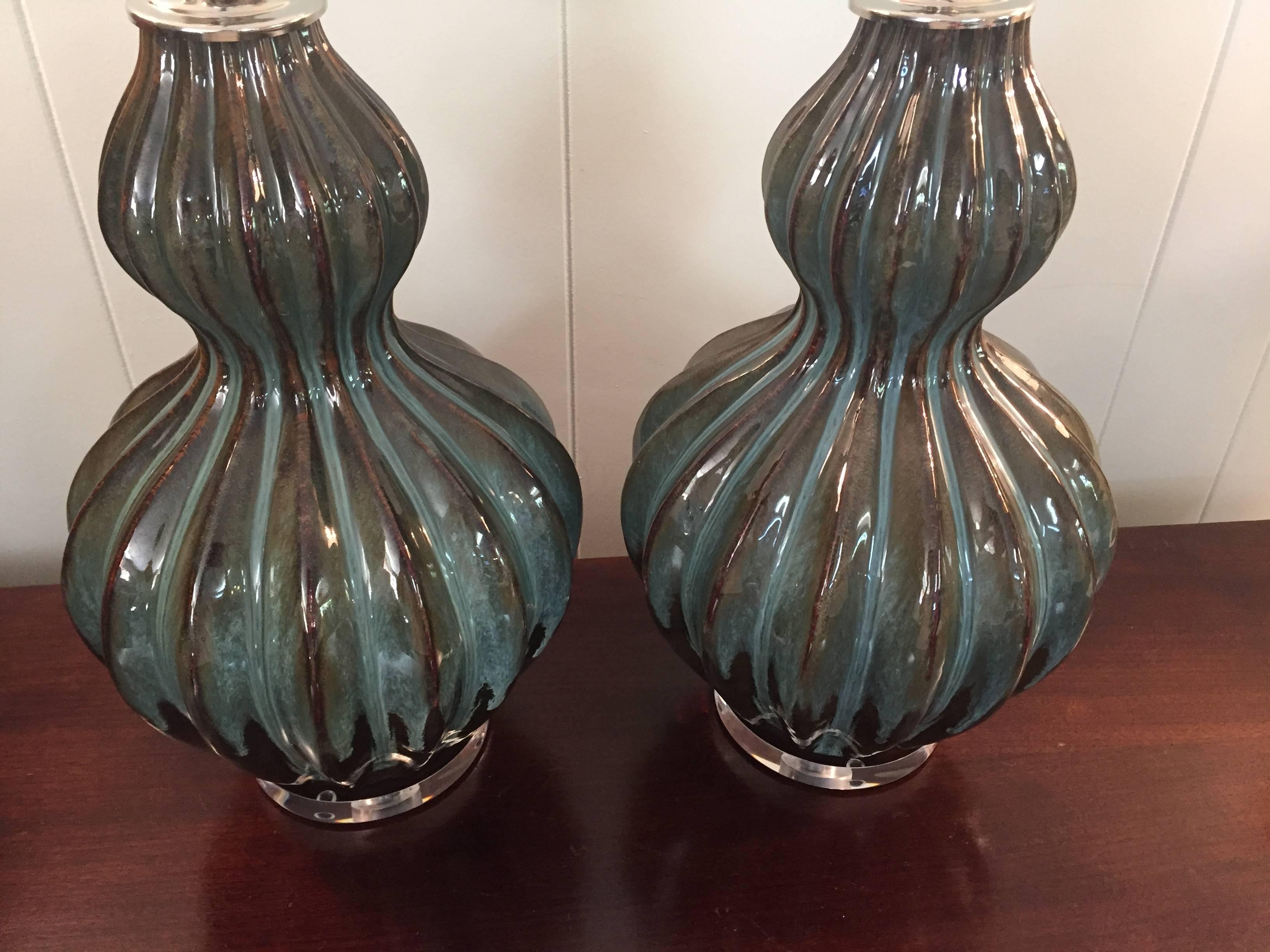Offered is a beautiful, pair of 1960s Italian turquoise and brown drip-glaze ceramic, hourglass/gourd shaped lamps. The pieces have new chrome caps, Lucite bases and wiring.