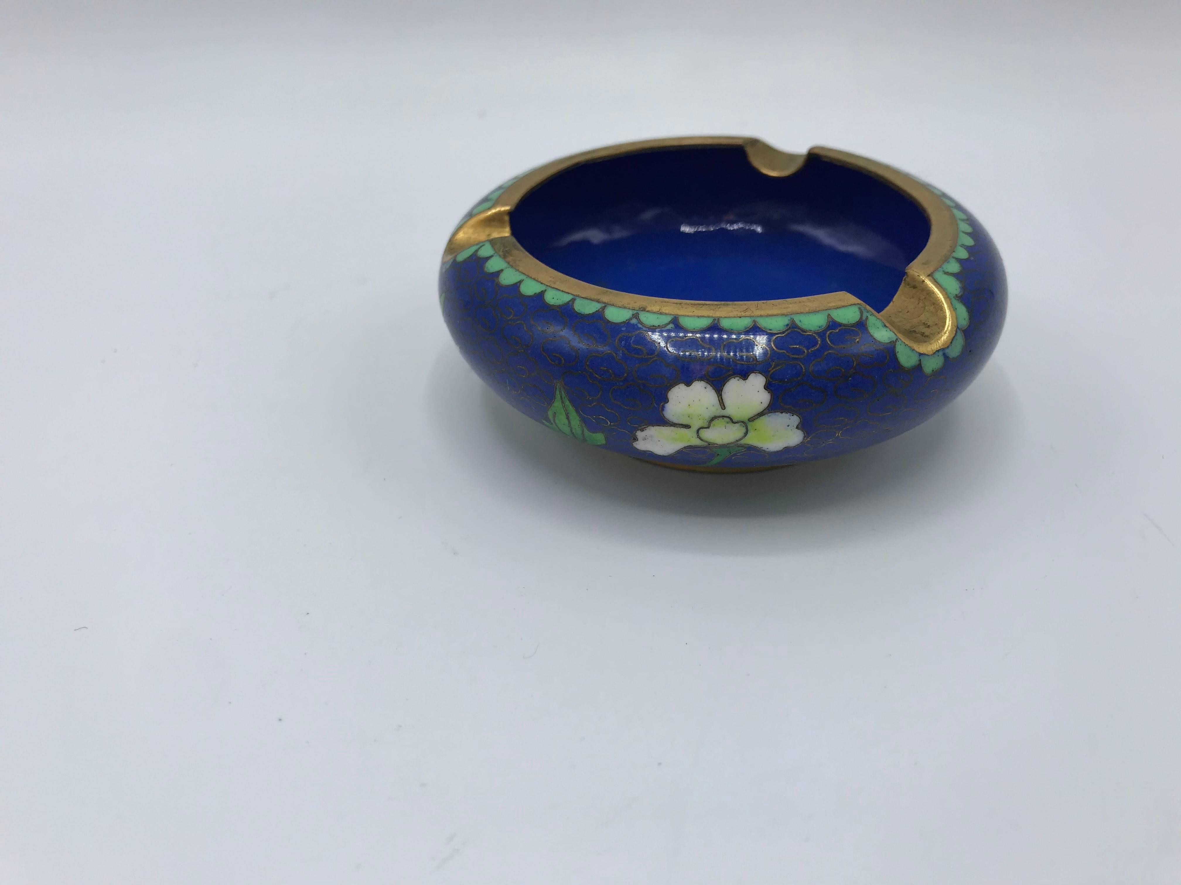 Offered is a gorgeous, small 1960s blue cloisonné ashtray with a thick brass lip. Looks like it has never been used.