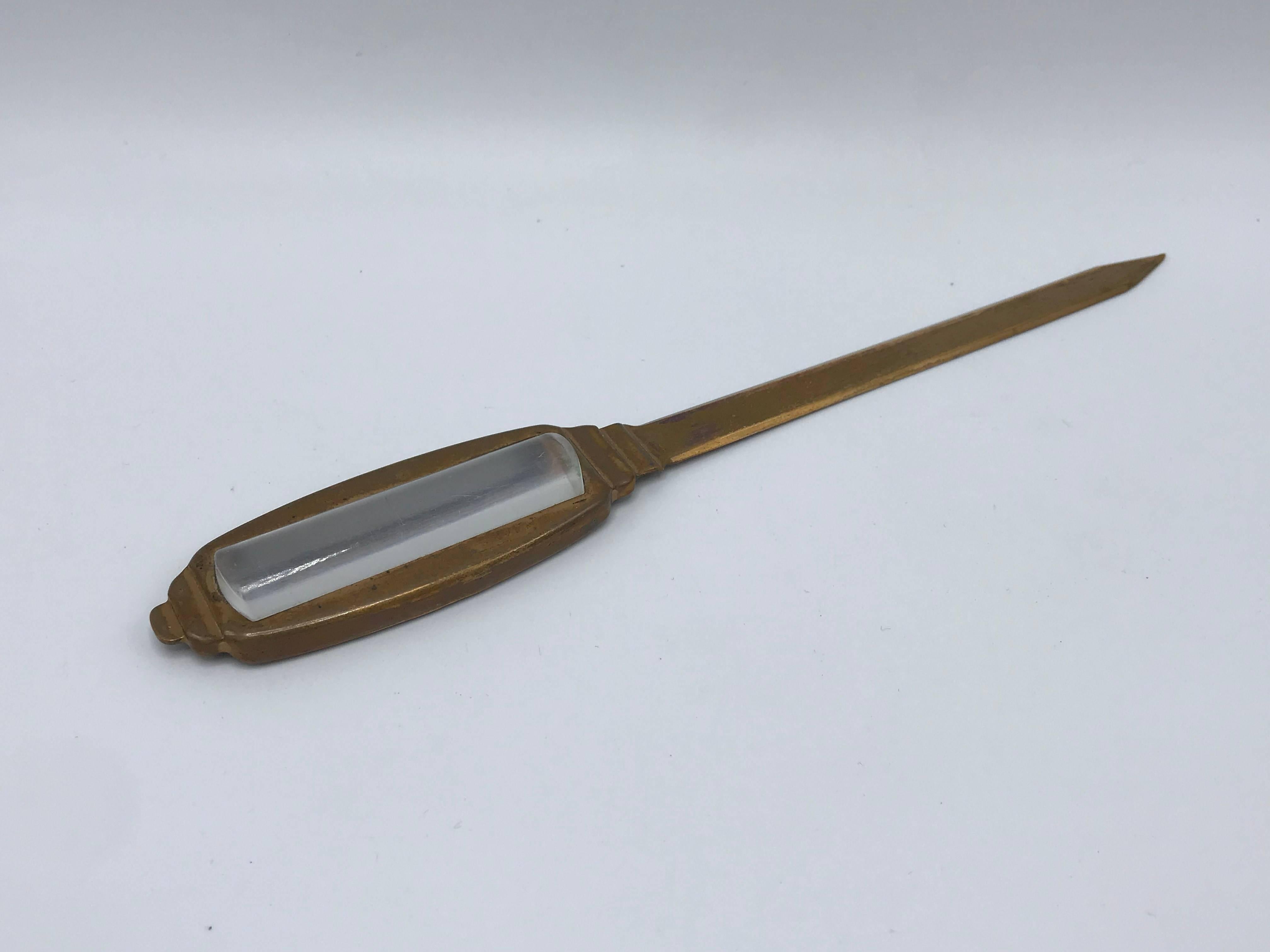 Offered is a modern and sophisticated, 1960s brass and Lucite letter opener/magnifying glass desk tool. Marked: Auto Point Co, USA. Light patina all-over, can be polished.