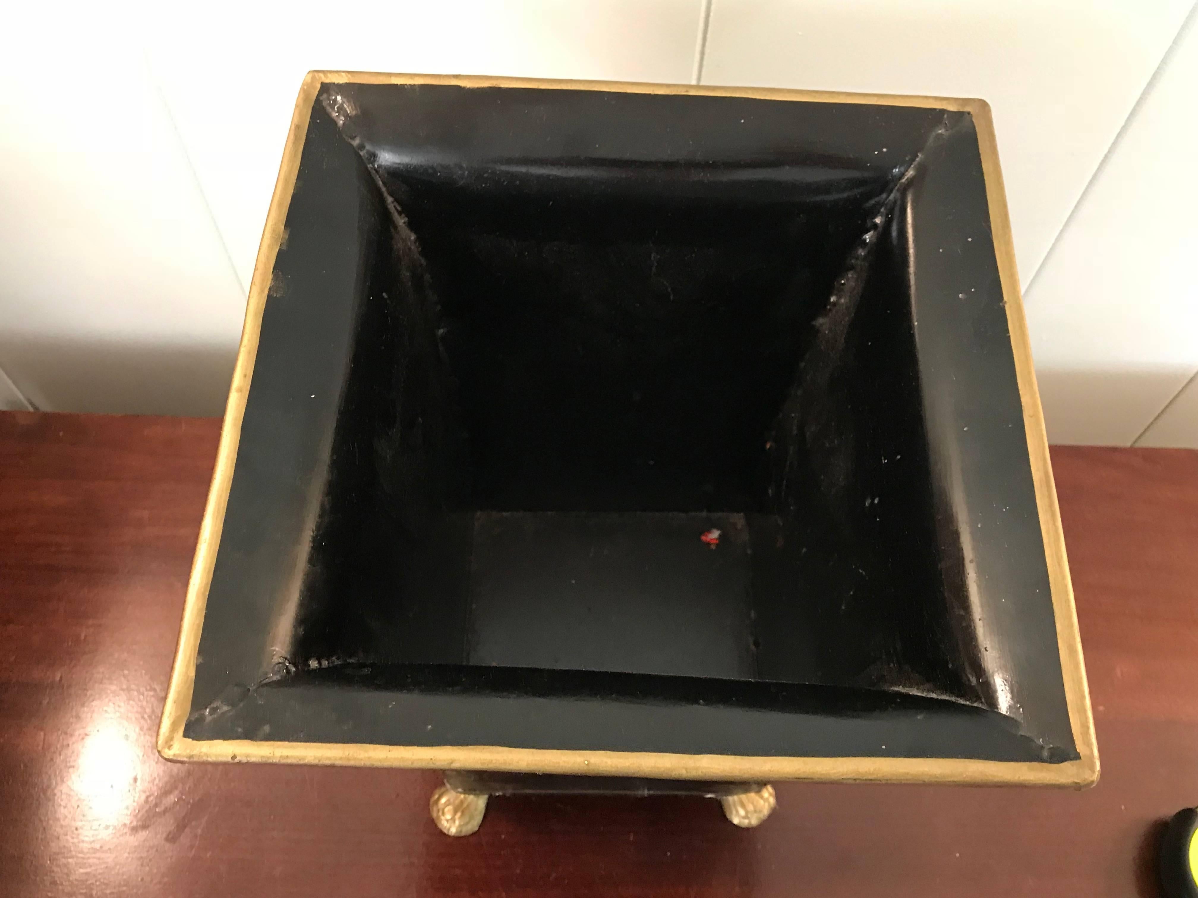 Offered is a beautiful, 1970s black and gold tole waste basket/cachepot. The piece has a stunning, all-around, gold wheat sheaf motif.