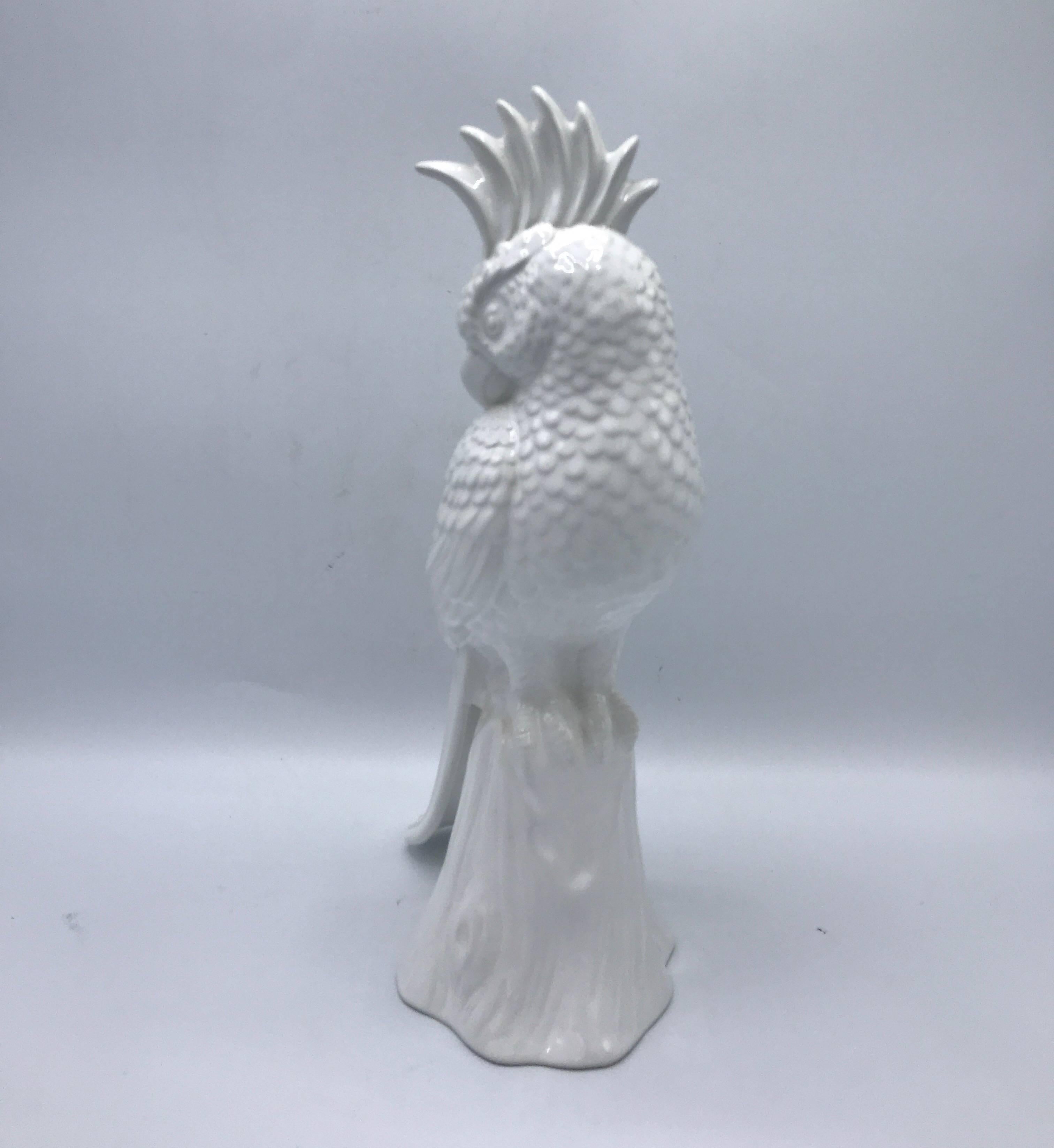 Offered is a gorgeous, 1960s Blanc de Chine ceramic cockatoo bird sculpture resting on a tree branch.