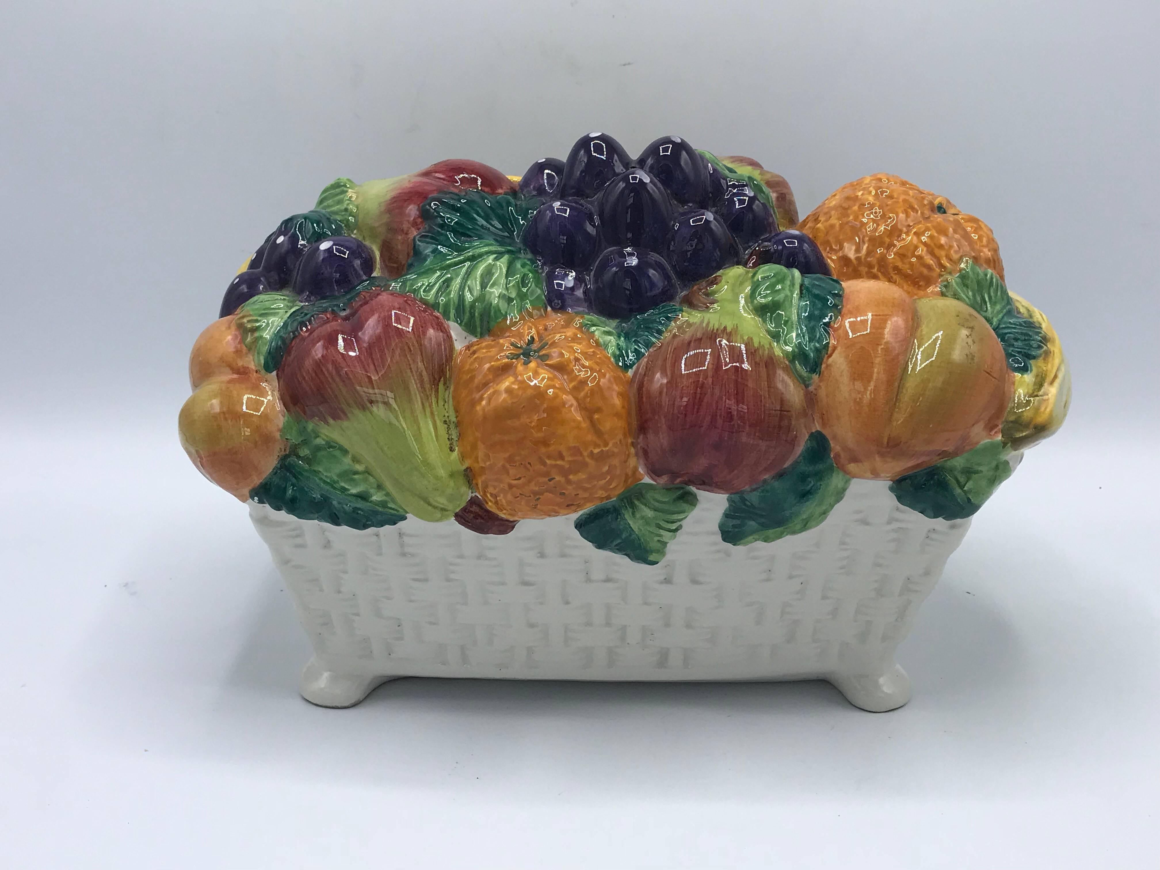 Offered is a fabulous, 1960s Hollywood Regency Italian ceramic fruit bowl sculpture. The beautiful basket adds a stunning touch. Amazing centerpiece! Heavy. All pieces are intact. No cracks, chips, or damage. Marked ‘Italy’ inside basket.