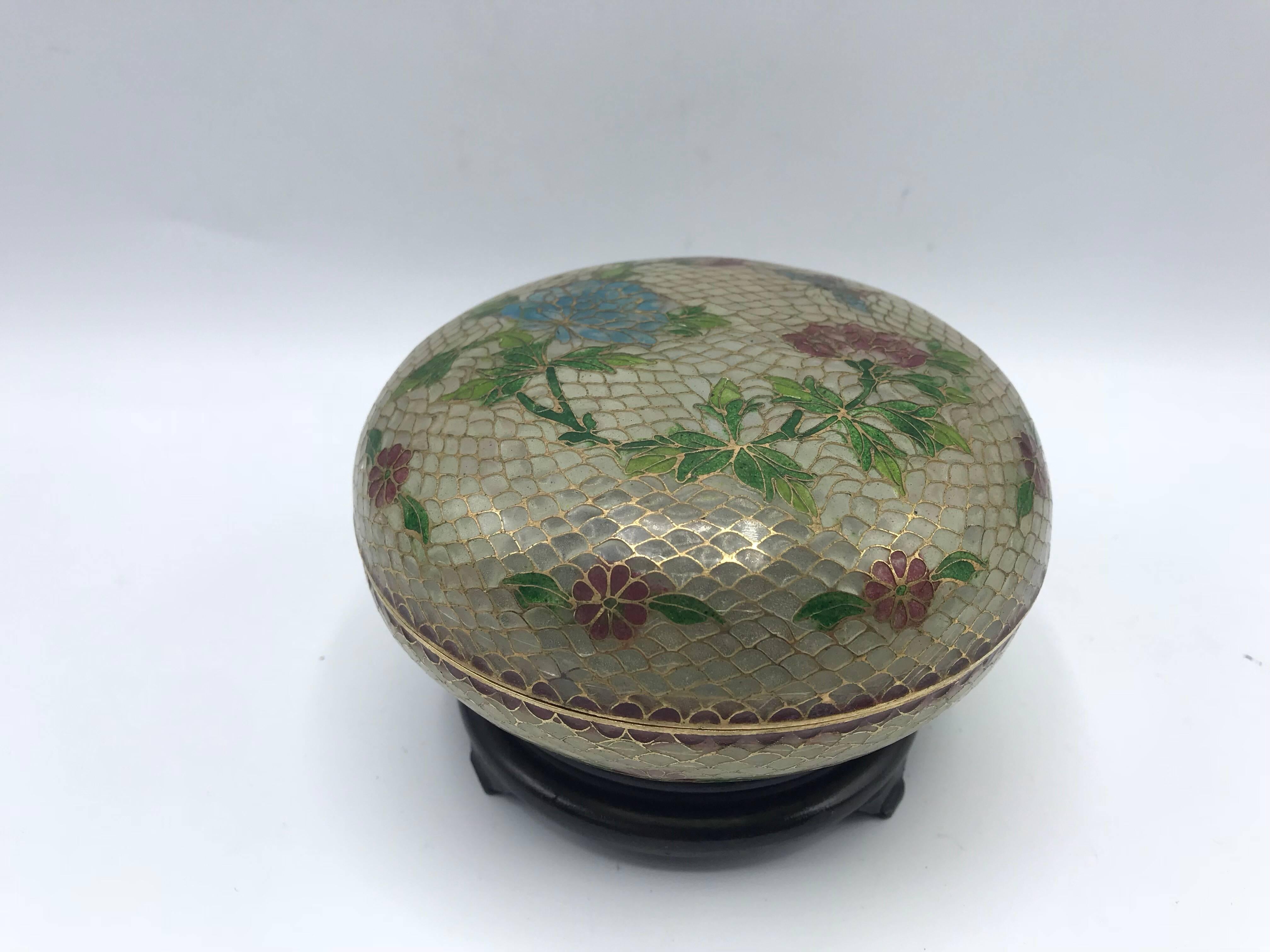 Offered is an exquisite, late 19th century French Art Nouveau, Plique a Jour cloisonné-enamel lidded bowl on a decorative wood stand. The piece has a gorgeous butterfly and floral-inlaid motif all over. 

Measures: With stand, 3.75” tall. Without