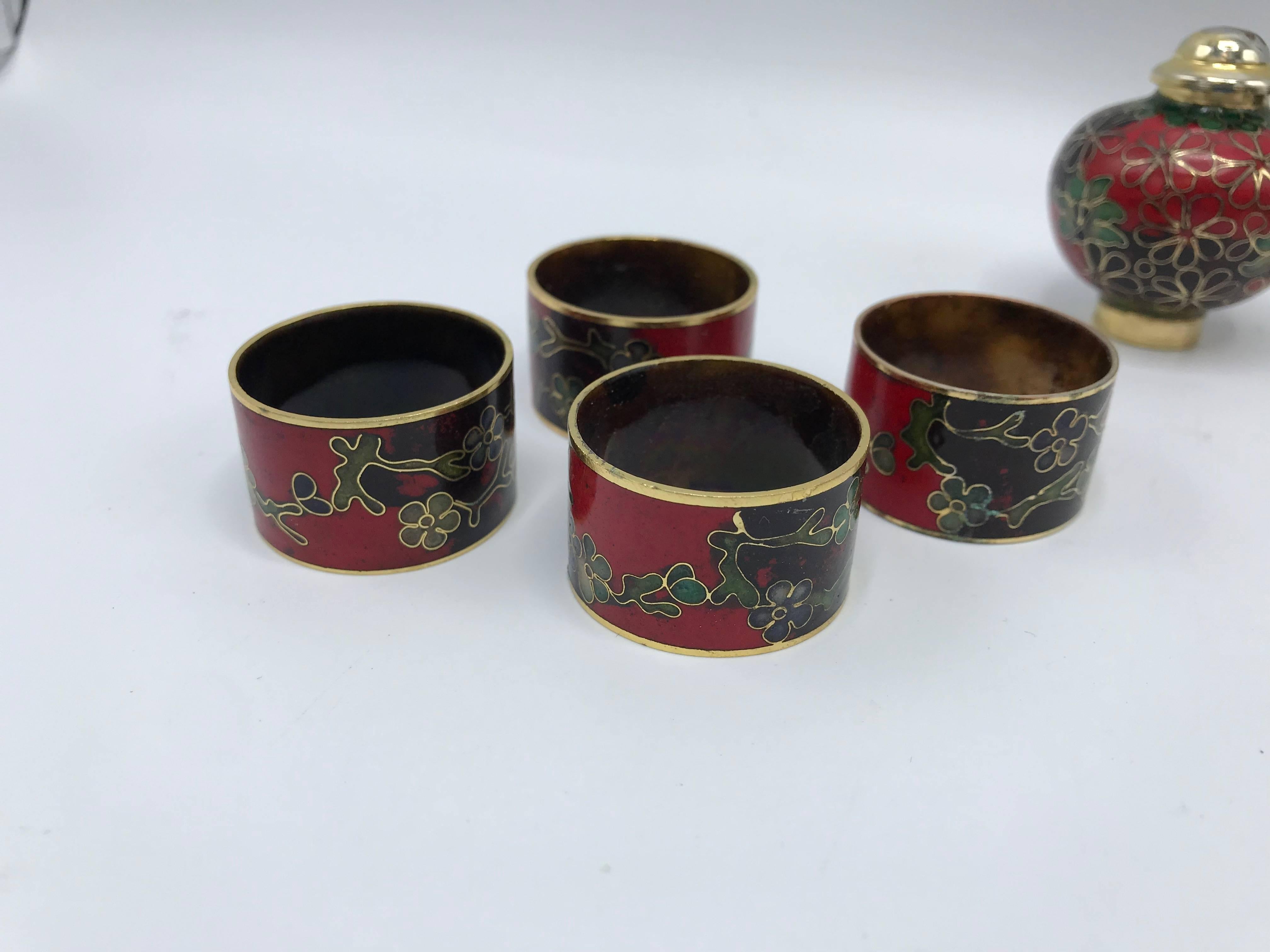 Offered is an immaculate, 1950s black and red cloisonné serving set with an ornate floral motif. The set of 11 includes; 8 napkin rings, a pair of salt and pepper shakers, and a toothpick holder. Fabulous touch of chinoiserie-chic to any table