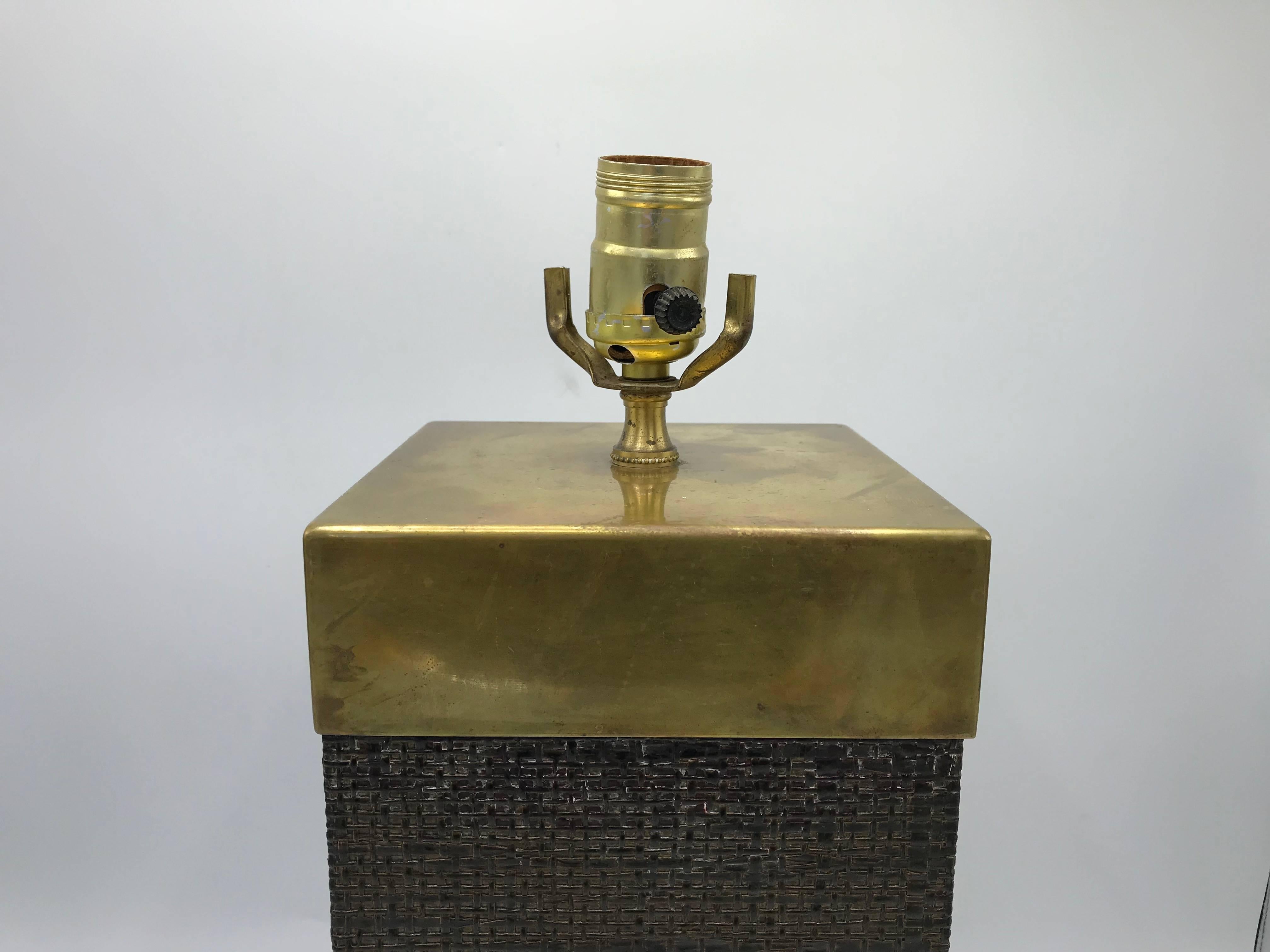 Offered is a fabulous, 1970s, Italian brass and lacquered grasscloth lamp, in the style of Karl Springer. Modern lines, in the shape of a rectangular cube. Heavy. Wired for standard, US use.