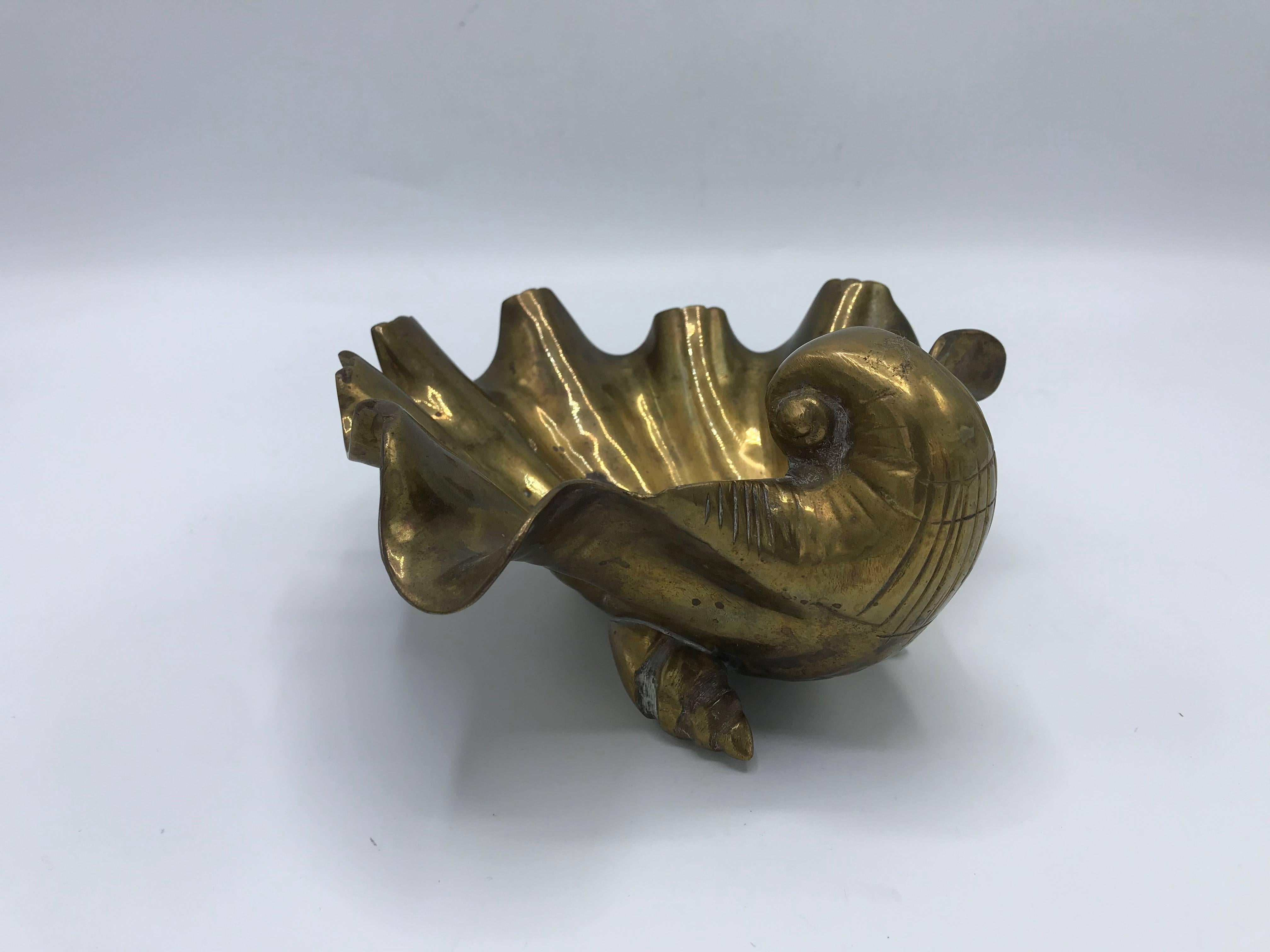 Offered is a beautiful, 1970s solid-brass seashell bowl or dish. The piece is footed with three small brass seashells. Heavy.