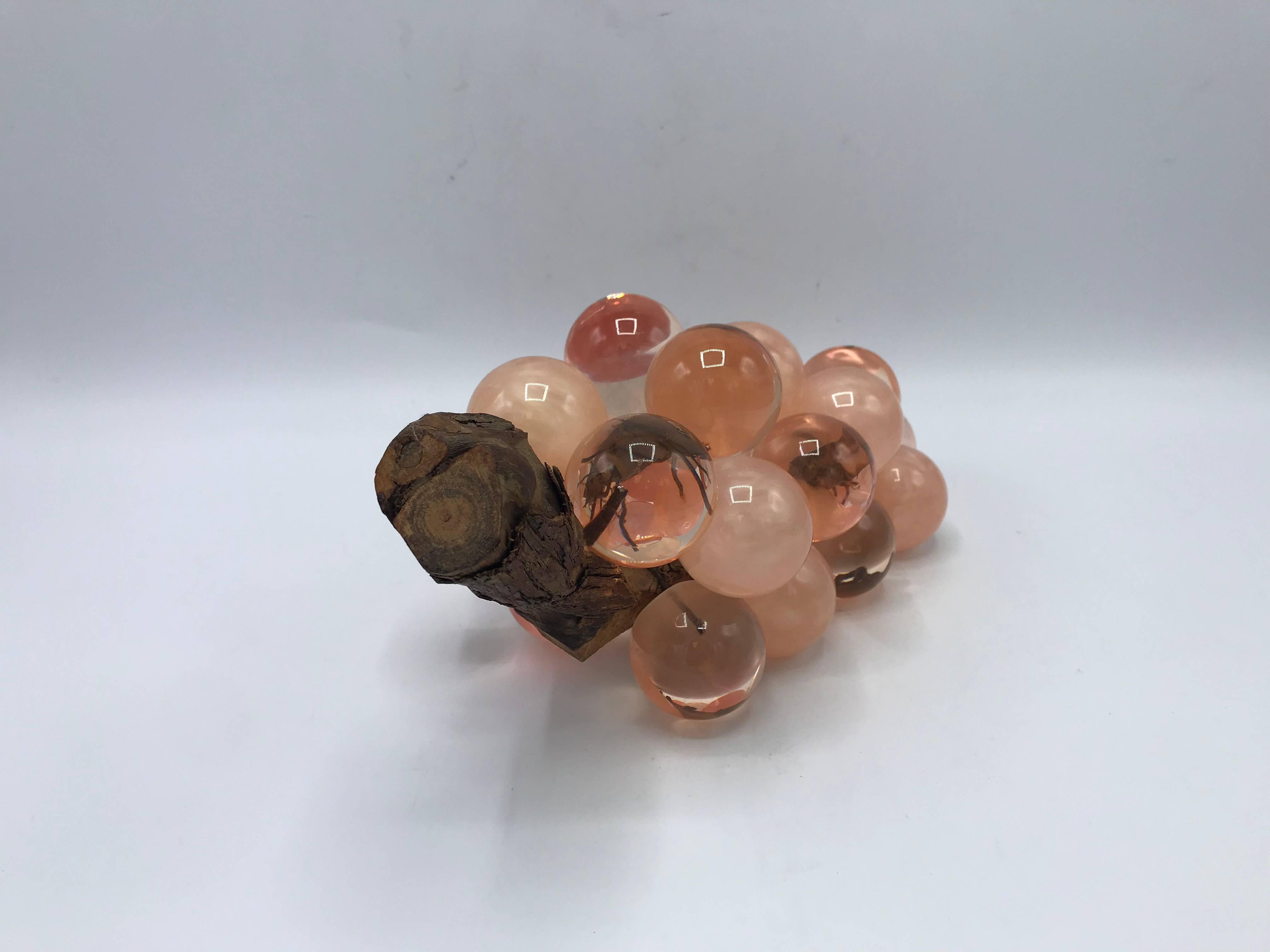 Offered is an exquisite, 1960's Italian lucite grape sculpture in several shades of pink. The sculpture is constructed of large lucite balls, attached with wire to a piece of driftwood. Heavy. 