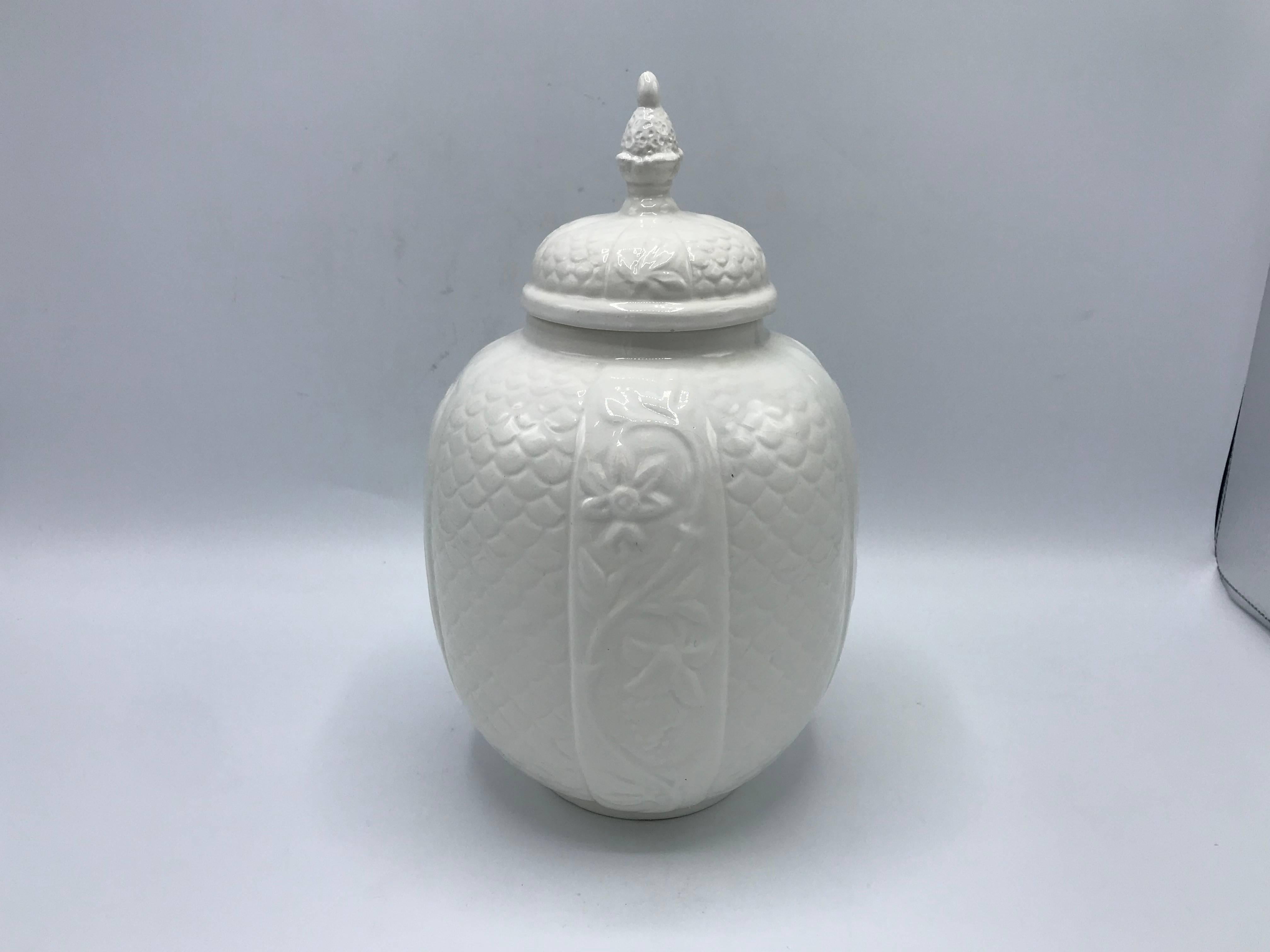 Offered is an exquisite, 1960s Italian white glazed-ceramic lidded jar or urn. The piece has a beautiful floral and scale motif, with a pineapple finial. Marked 