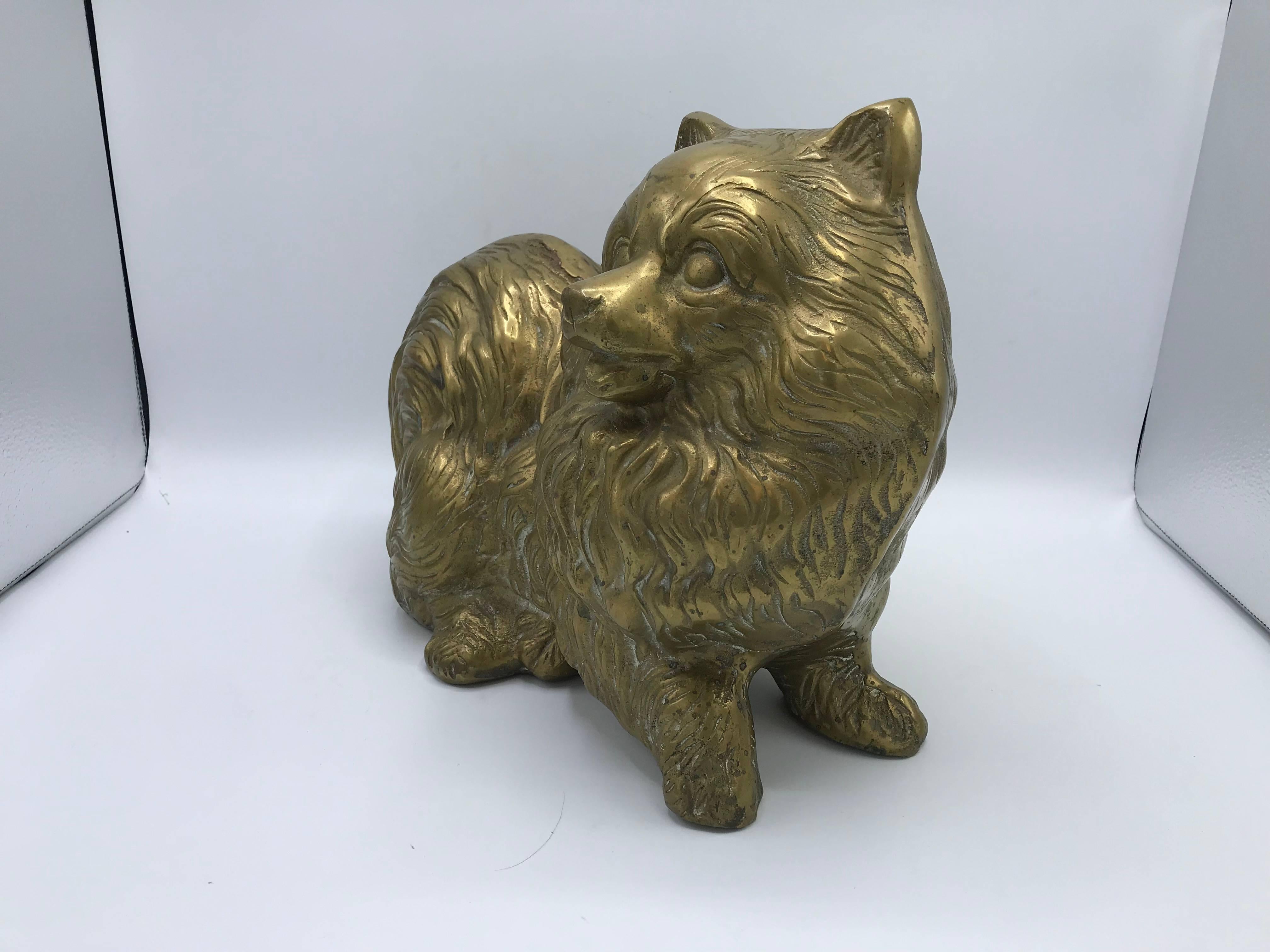 Listed is a fabulous, 1960s life-size brass Pomeranian dog sculpture. Beautiful, Hollywood Regency flare! Heavy, weighing 14ibs.