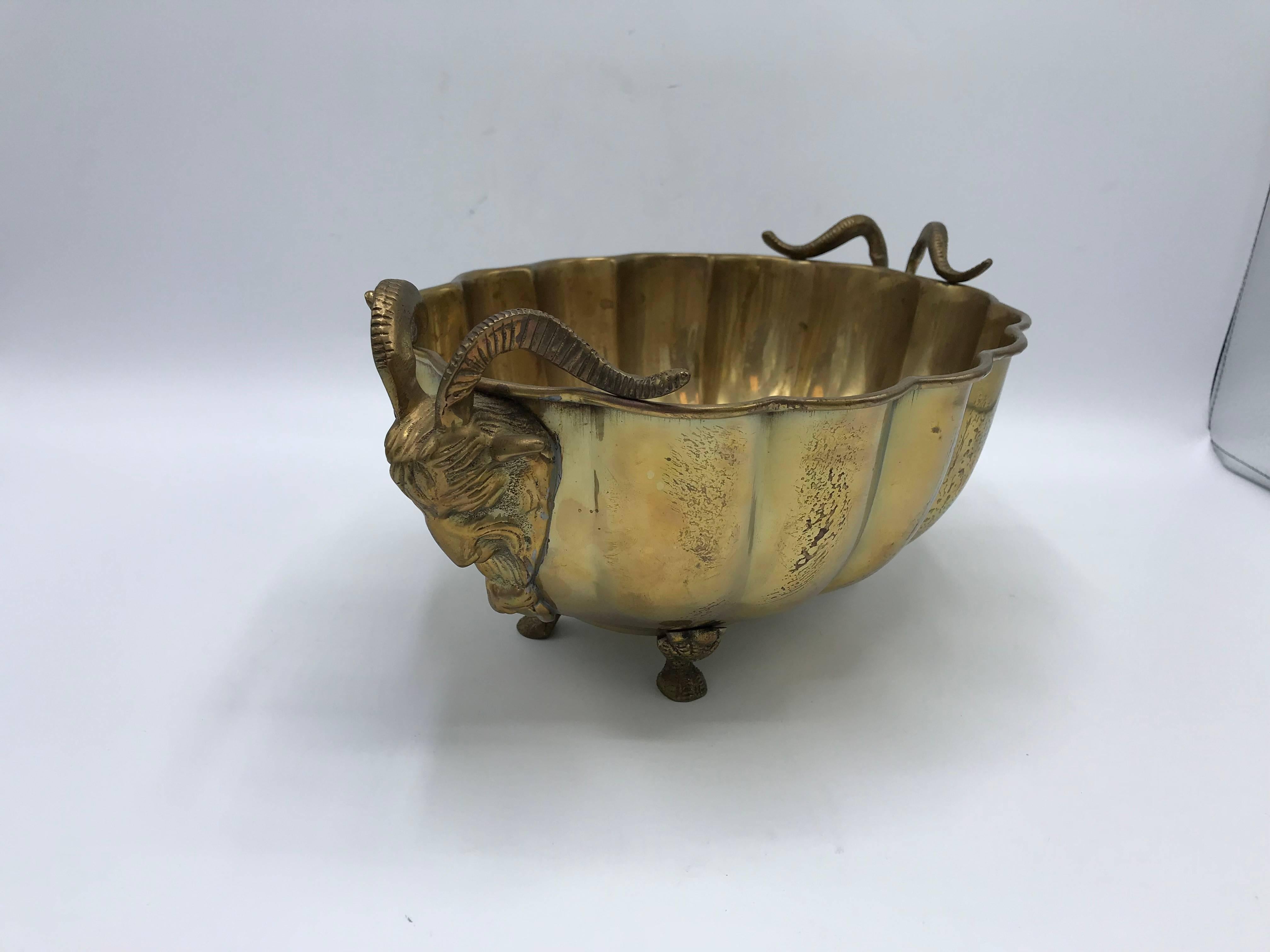 Listed is a fabulous, 1960s Italian brass cachepot planter bowl. The piece has a beautiful, scalloped edge, rams head handles, and hoof feet. Lovely aged brass patina all-over, can easily be polished by buyer. Heavy.