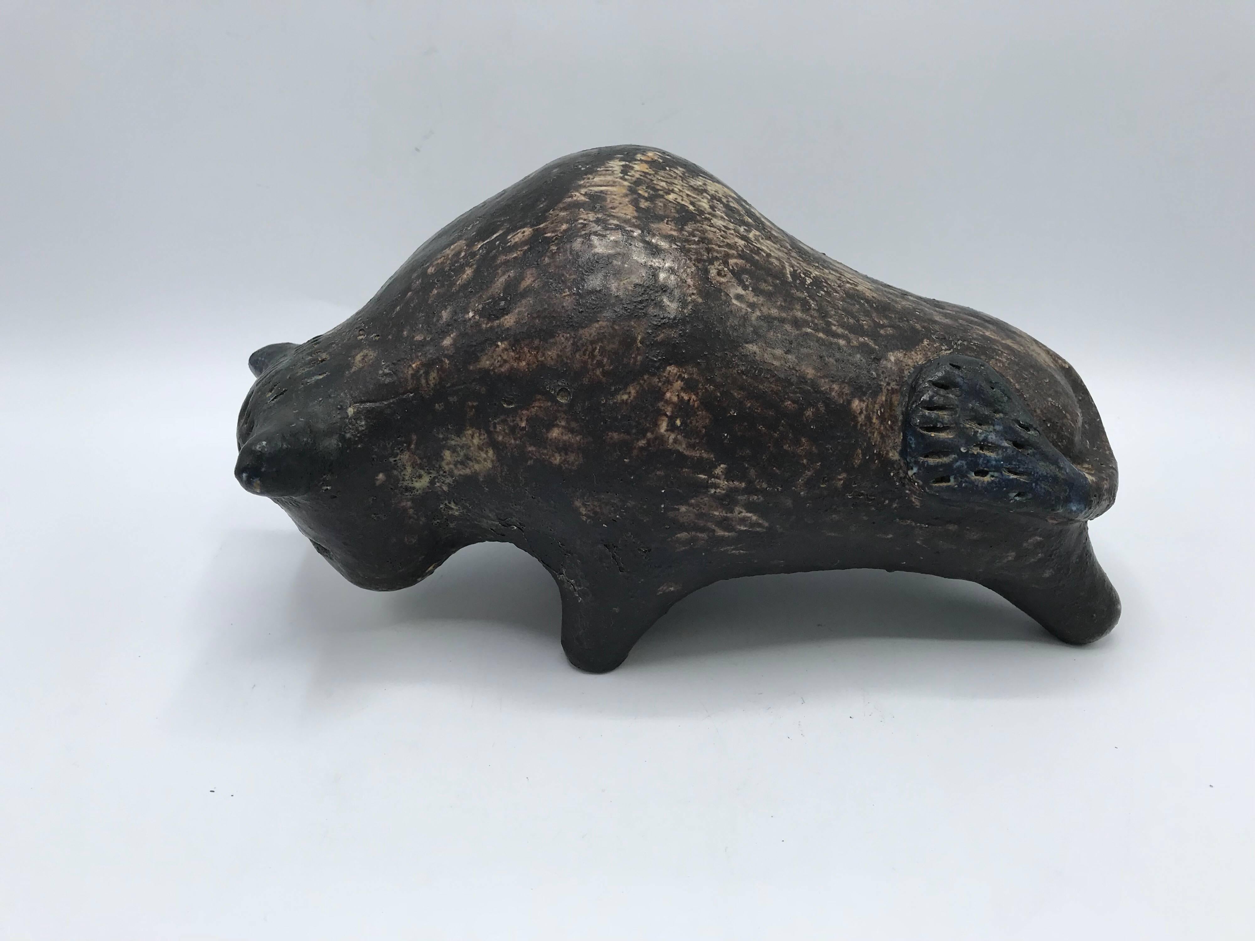 Listed is a fabulous, Italian Mid-Century Modern, 1960s Bitossi style ceramic pottery bull sculpture. The brown coloring has a semi-gloss finish to the ceramic.