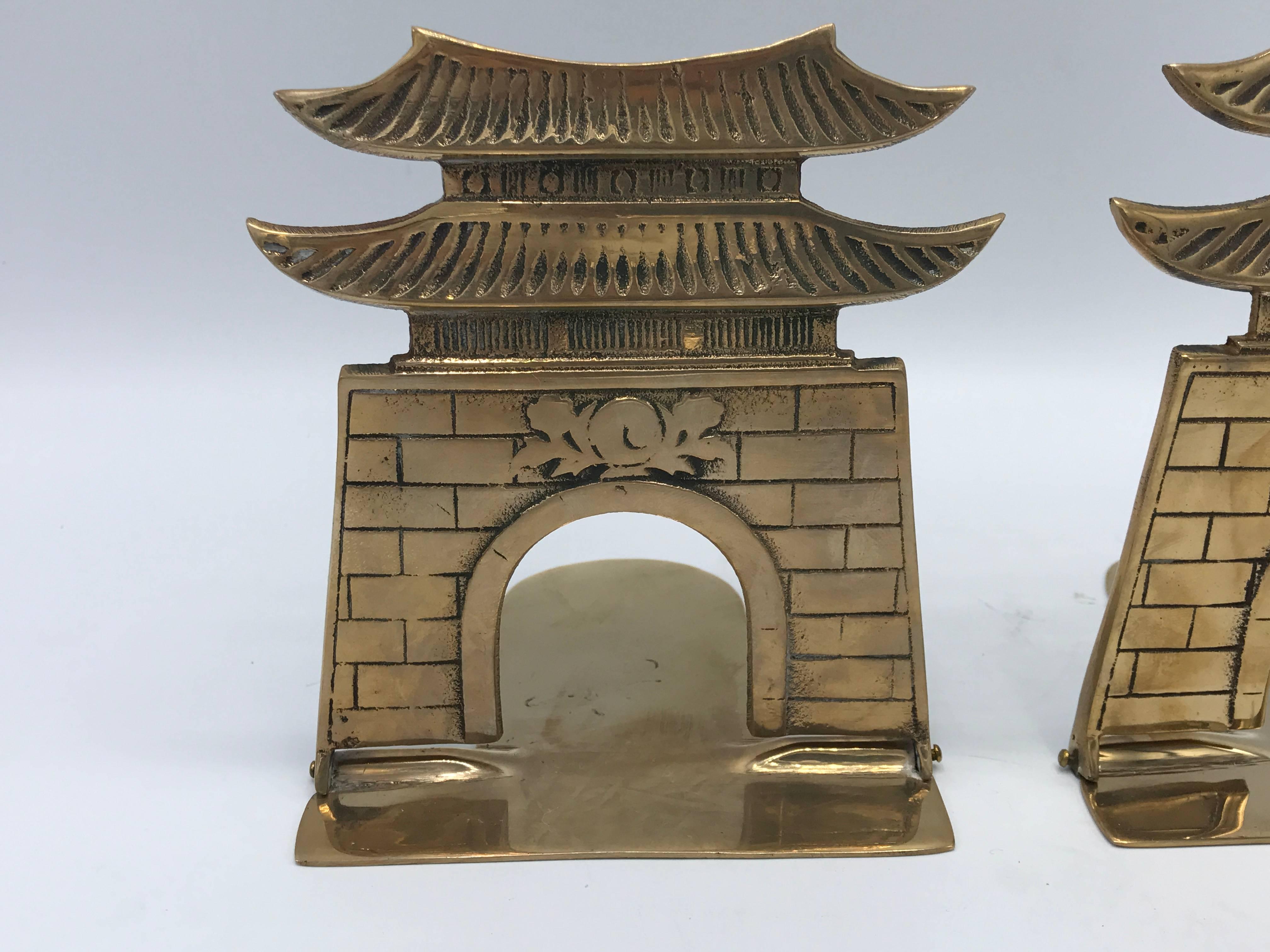 Offered is a gorgeous, pair of 1970s folding brass pagoda bookends. The bottom (folds out) sits underneath books, allowing the pair to hold a substantial weight upright.
 