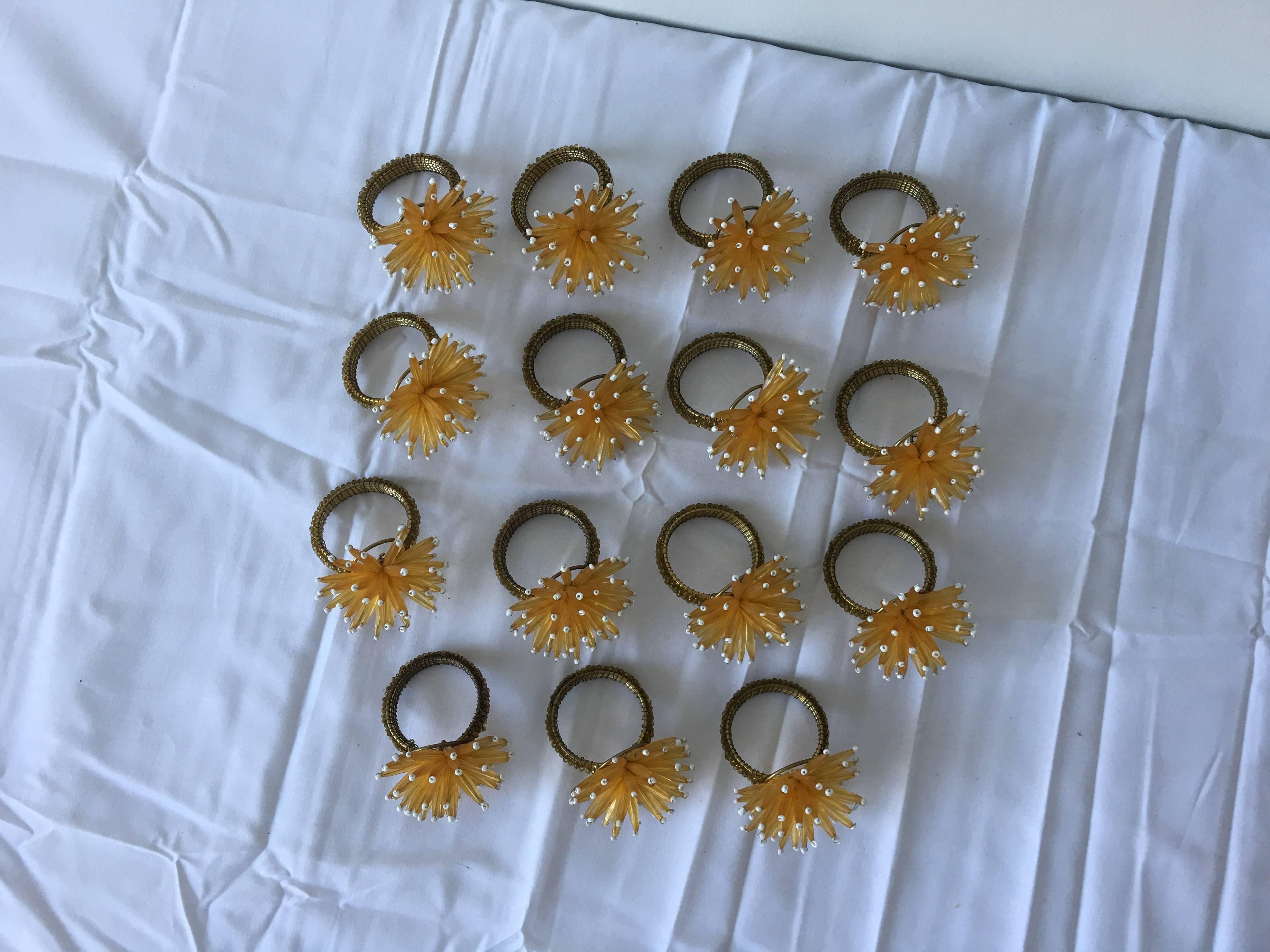 An immaculate set of 16, 1980s yellow and gold beaded starburst napkin rings. Modern with a sophisticated twist of glam!