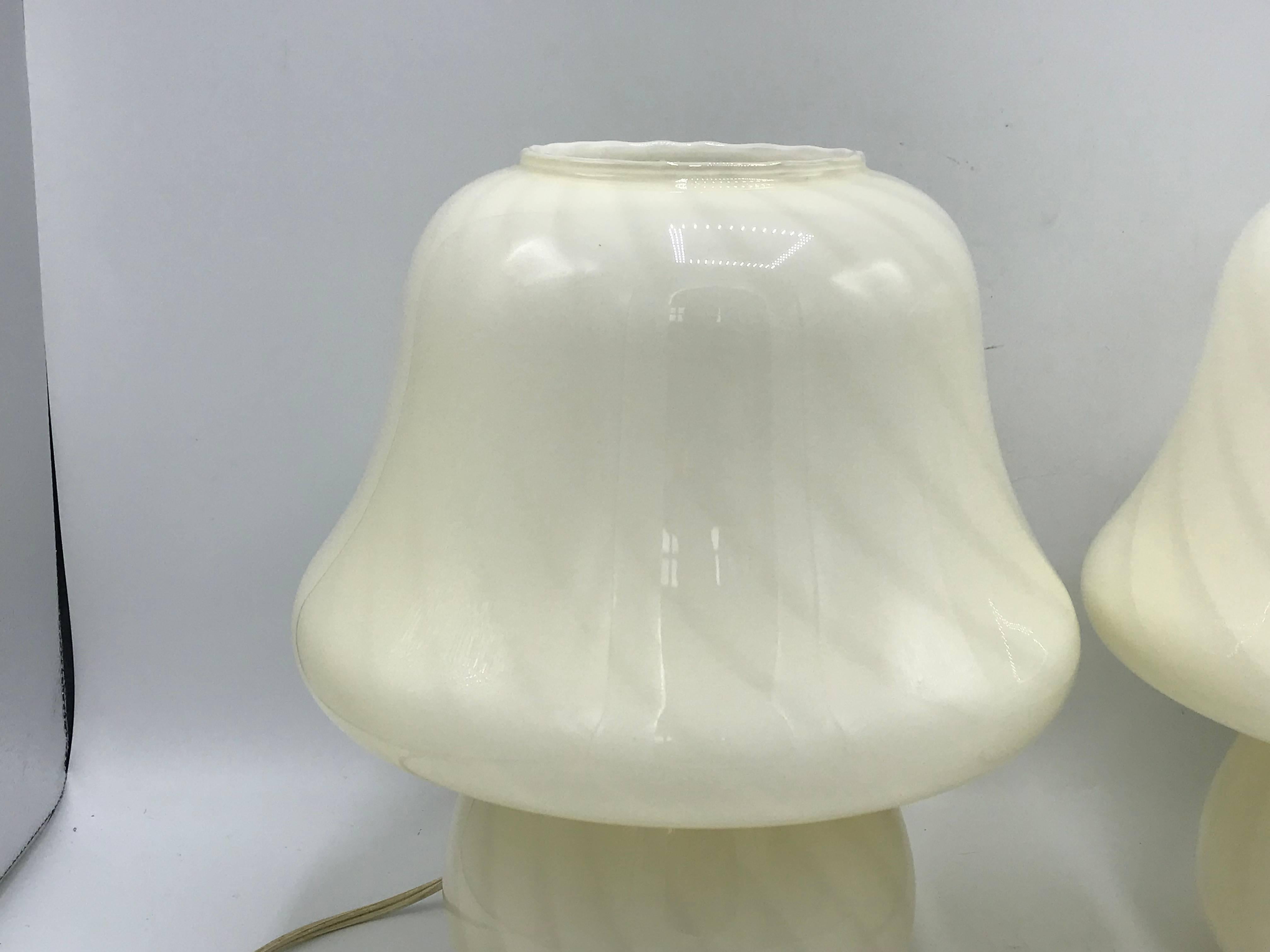 Listed is an exquisite, pair of 1970s Italian, white Murano glass lamps. The pair of mushroom lamps were designed by world-renowned Vetri. Felt-lined underside.