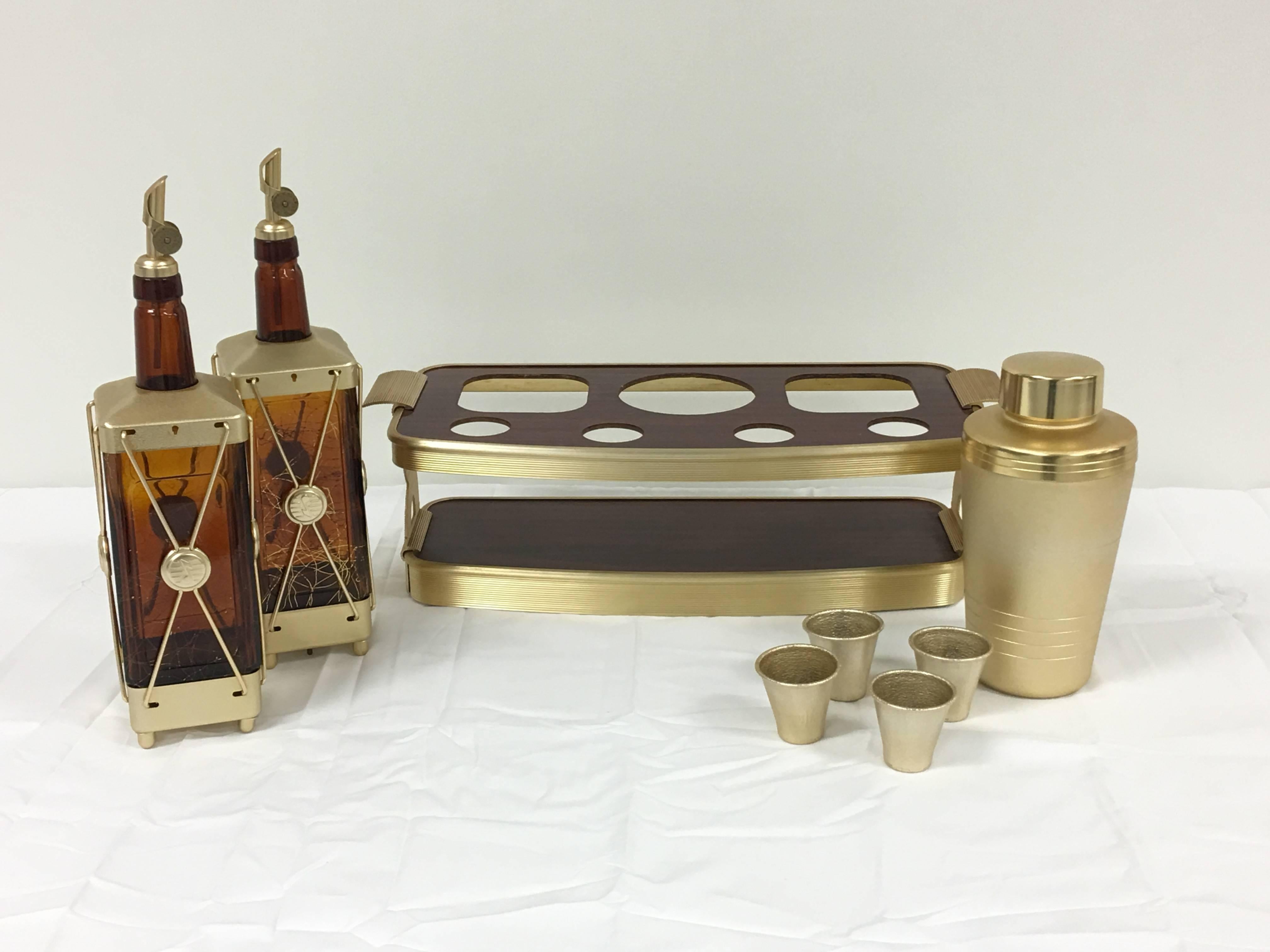 Offered is an absolutely gorgeous, burl wood veneer and gold stainless steel cocktail bar set. Set includes four shot glasses, one shaker with lid, two glass pourers, and one bar tray.