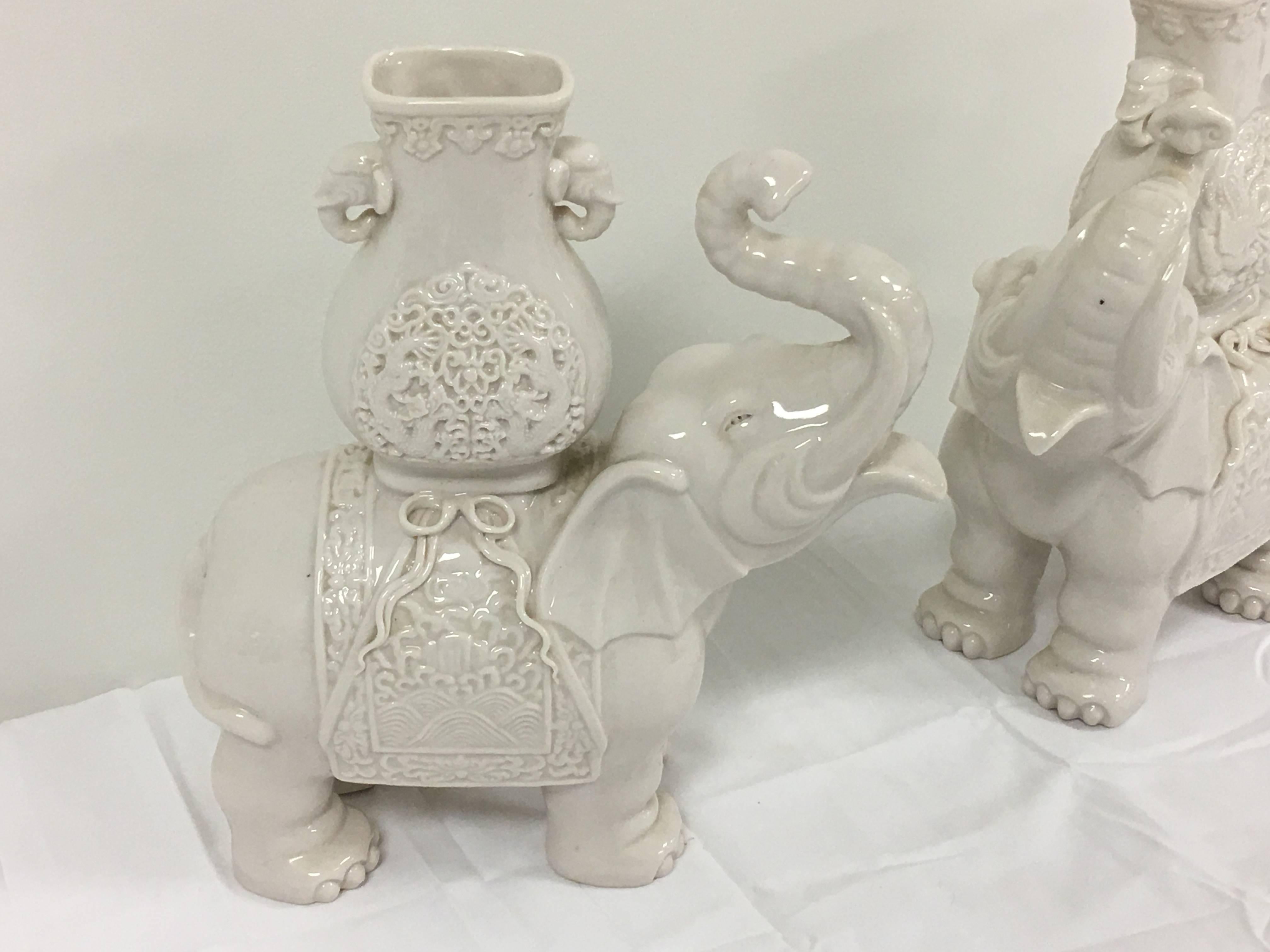 Offered is a fabulous pair of 1950's Blanc de Chine elephant statue figurines. Each has beautiful detailing, with a 'basket' on their backs.

Total of two pairs available. Price reflects each pair. 