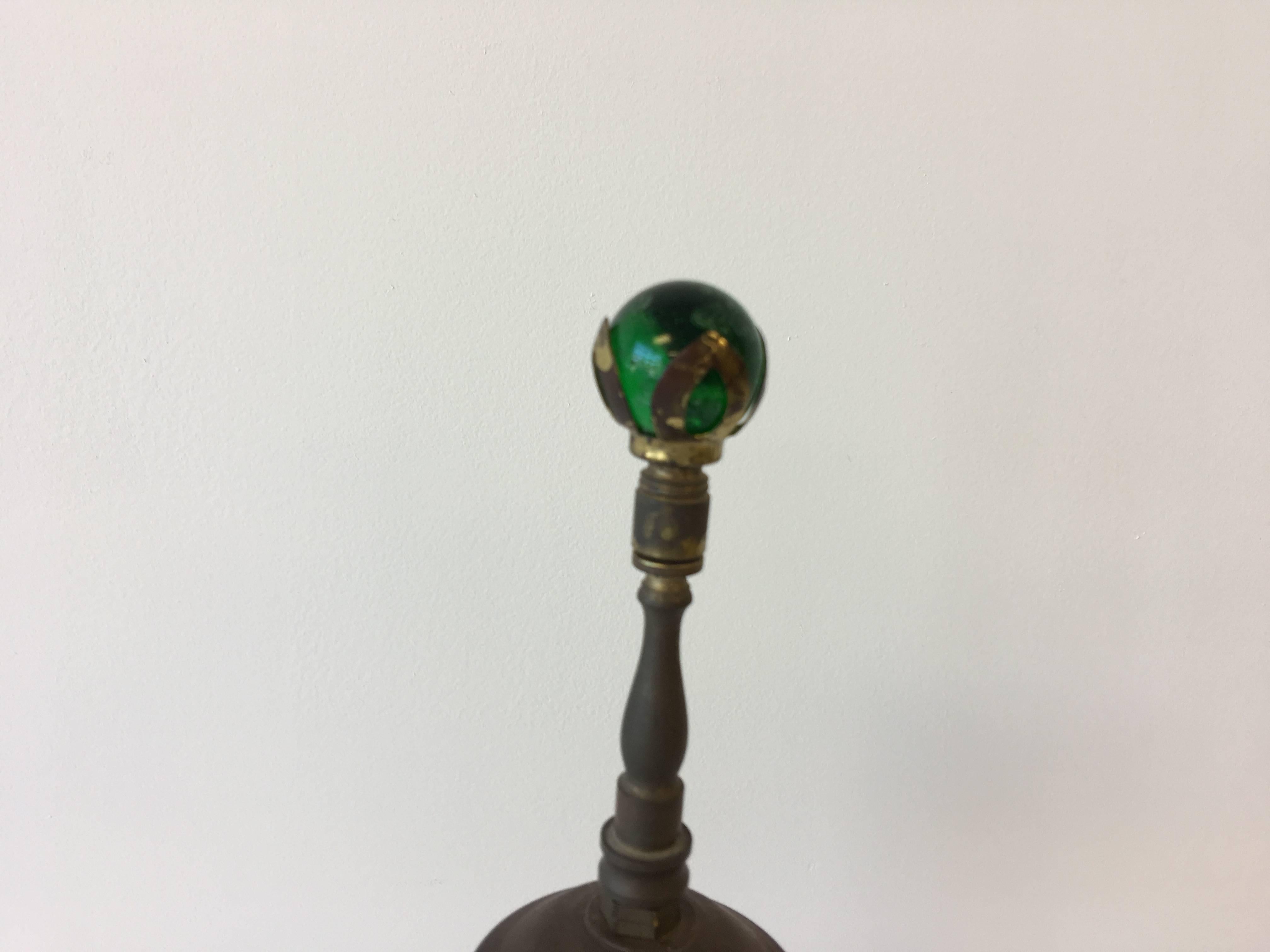 Listed is a fabulous, antique bronze and white onyx lamp with a cherub angel motif. This lamp has a Dual socket. Electrical is in great-working condition. Original emerald green art glass finial with brass harware. No shade included. 