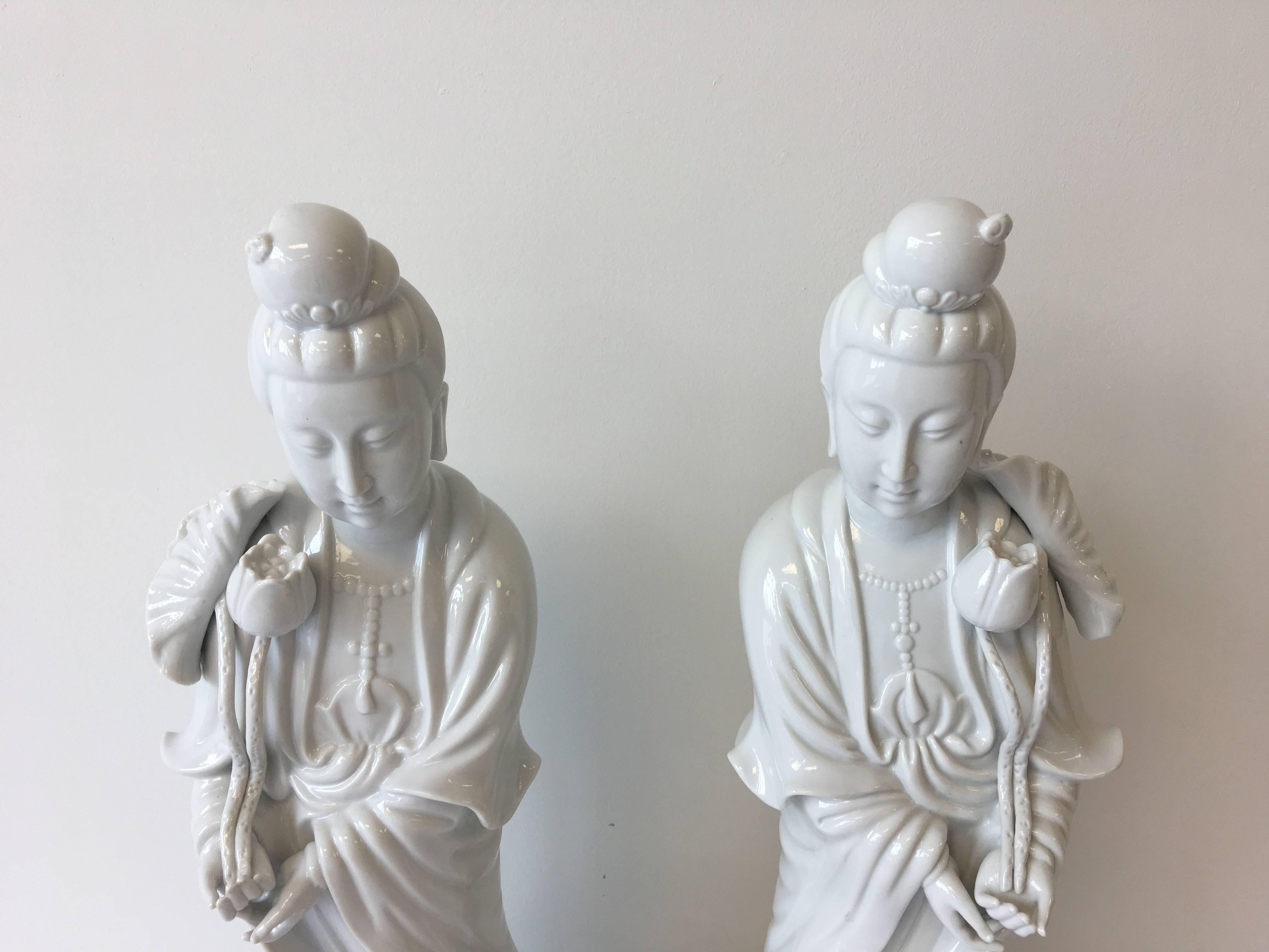 An absolutely stunning, pair of antique Blanc de Chine statues of Guan Yin. 20th century, circa 1960's. The Buddhist goddess of compassion, mercy, and kindness is truly embodied in these fabulous, pure-white porcelain pieces! They stand tall (24