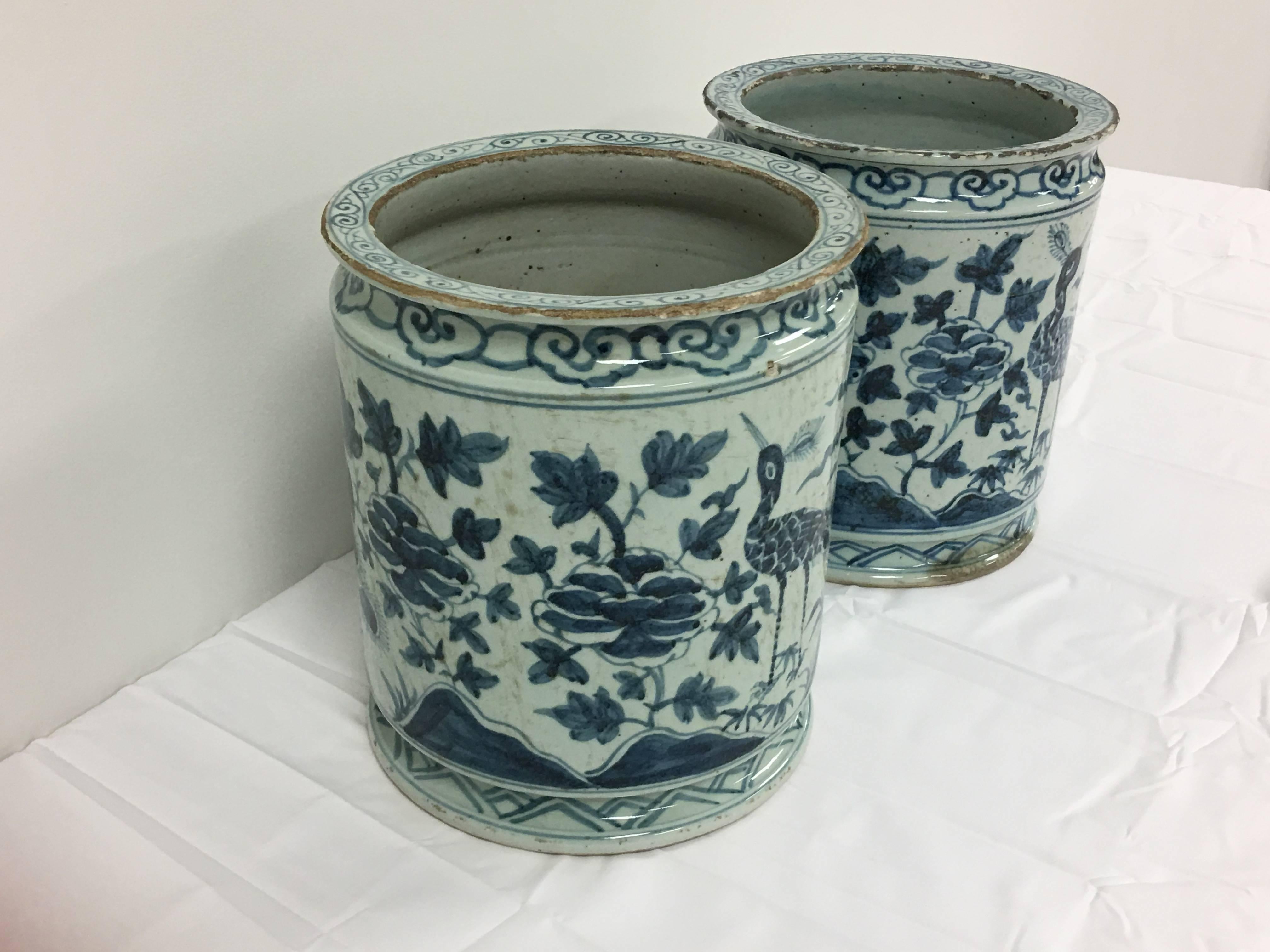 A fabulous pair of antique, blue and white Asian planters. The pair has a gorgeous peacock and floral motif that wraps around. These would be perfect indoors or out!