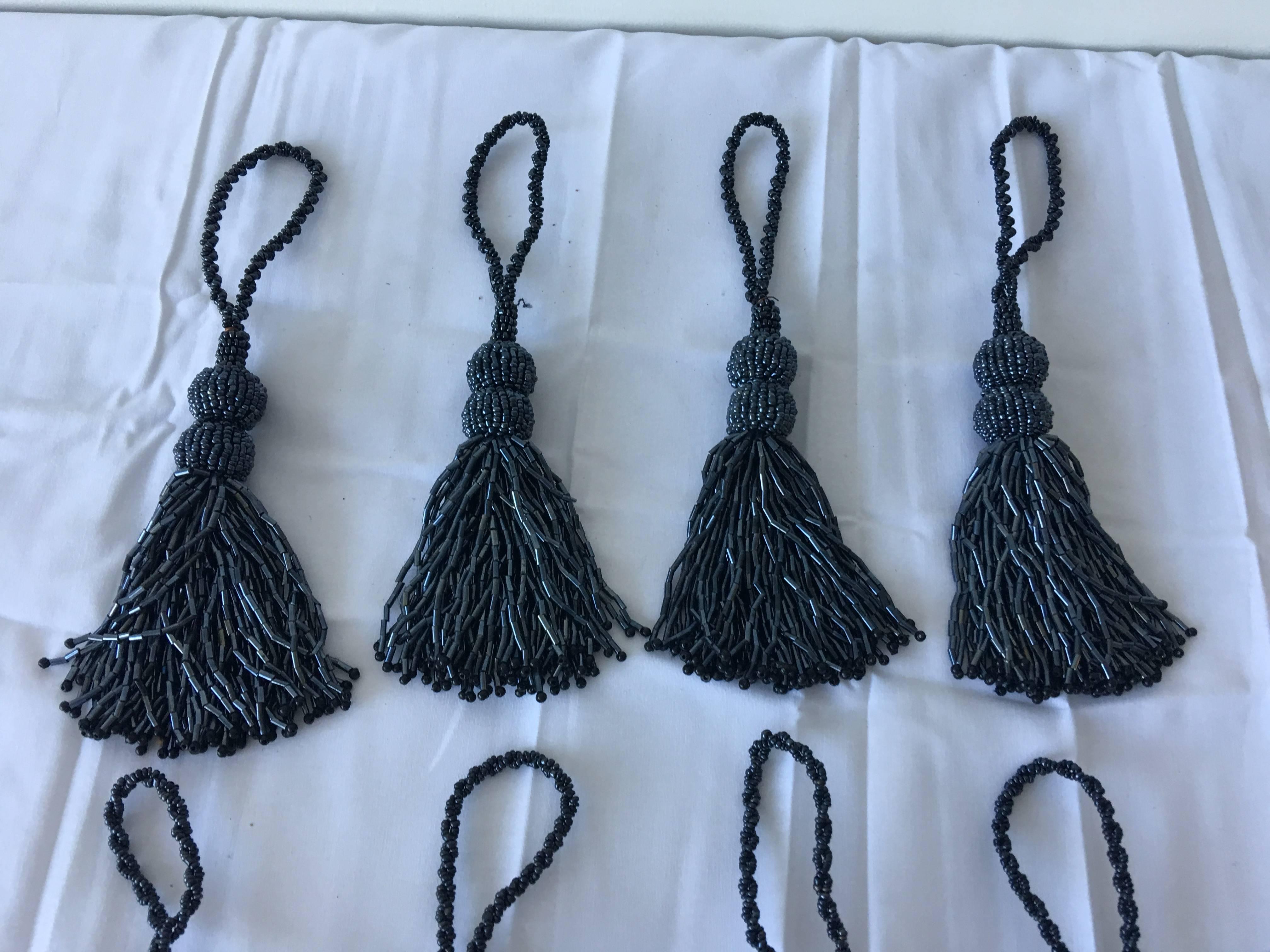 Modern and sophisticated, with a flair of glam! Set of 11 slate grey, beaded tassel napkin rings.
