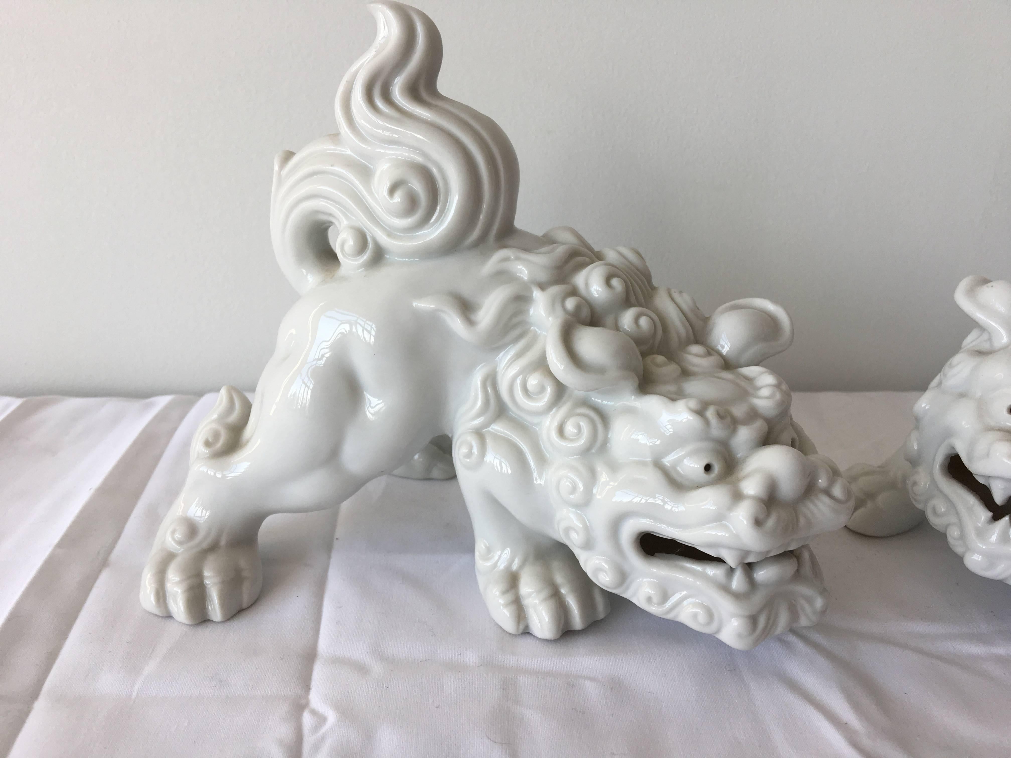 Listed is an absolutely stunning pair of porcelain, Blanc de Chine foo dogs! Beautiful addition of chinioserie flare to any decor!