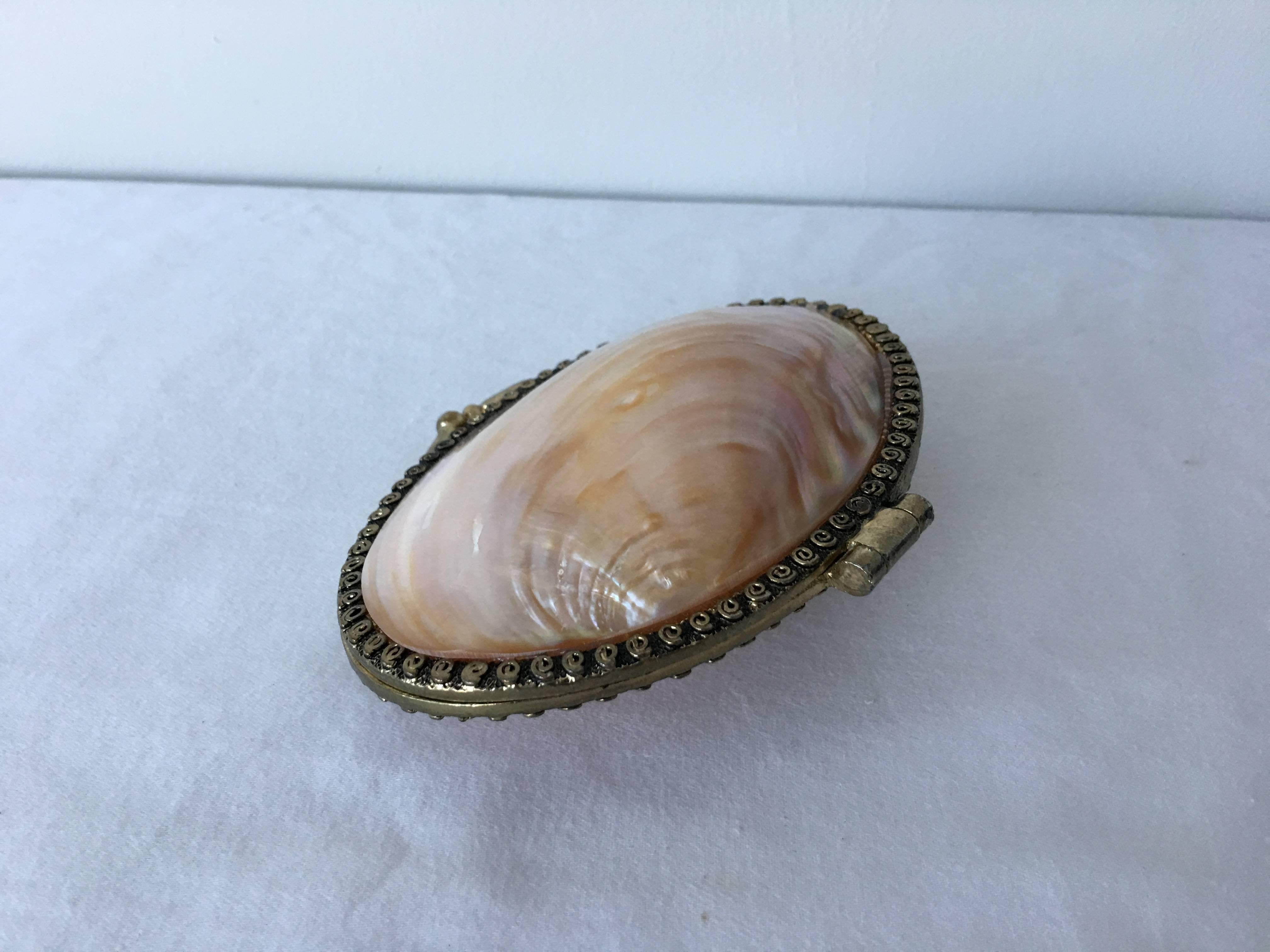 An exceptional, 20th century mother-of-pearl shell trinket box or coin purse. Clasp is in excellent condition, still holds a tight grip.