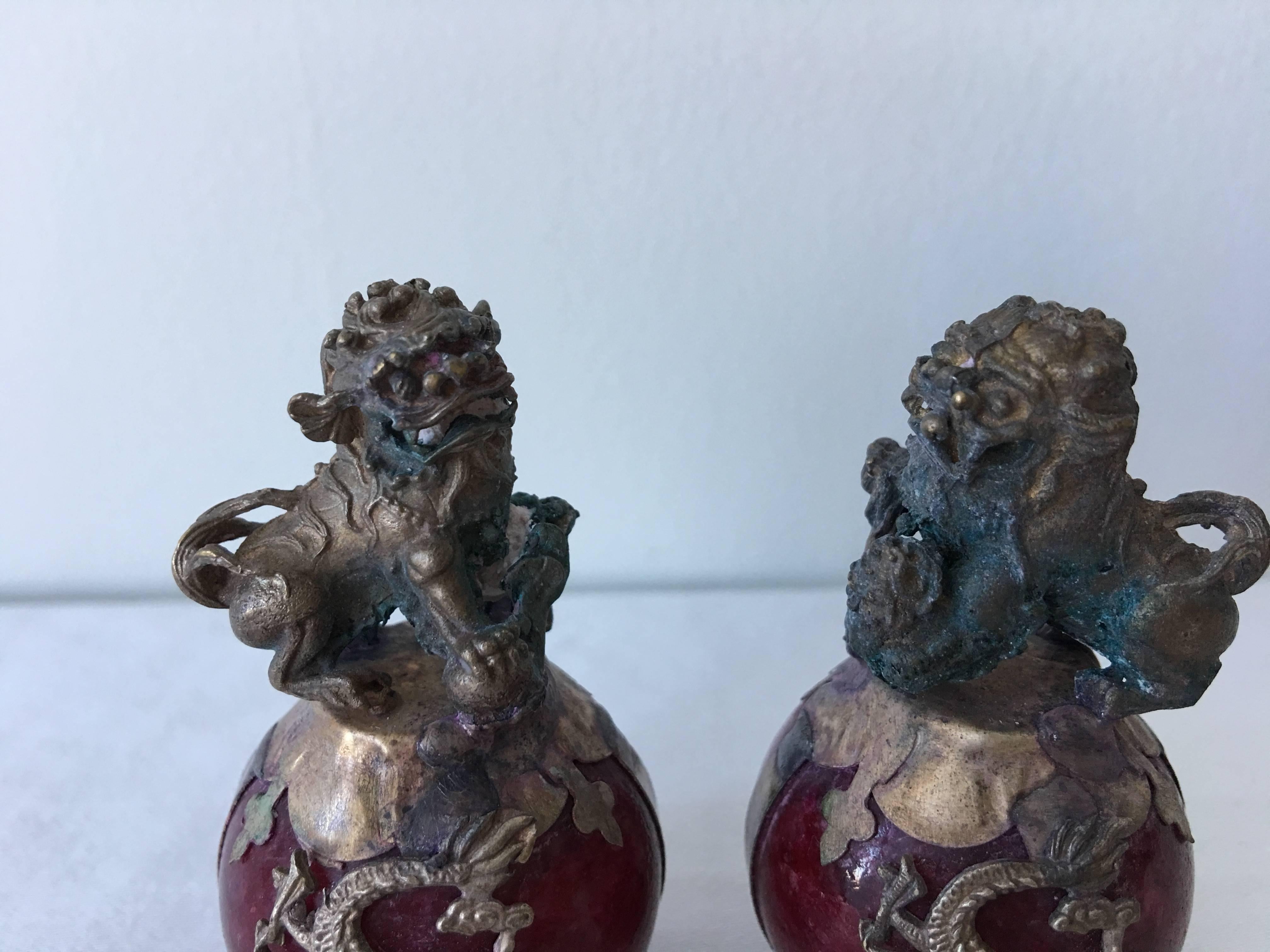 Offered is an immaculate pair of 19th century, miniature bronze foo dog statues. Each are rested upon a red stone orb with a dragon wrapping around it. Extremely rare, especially in such extraordinary condition.