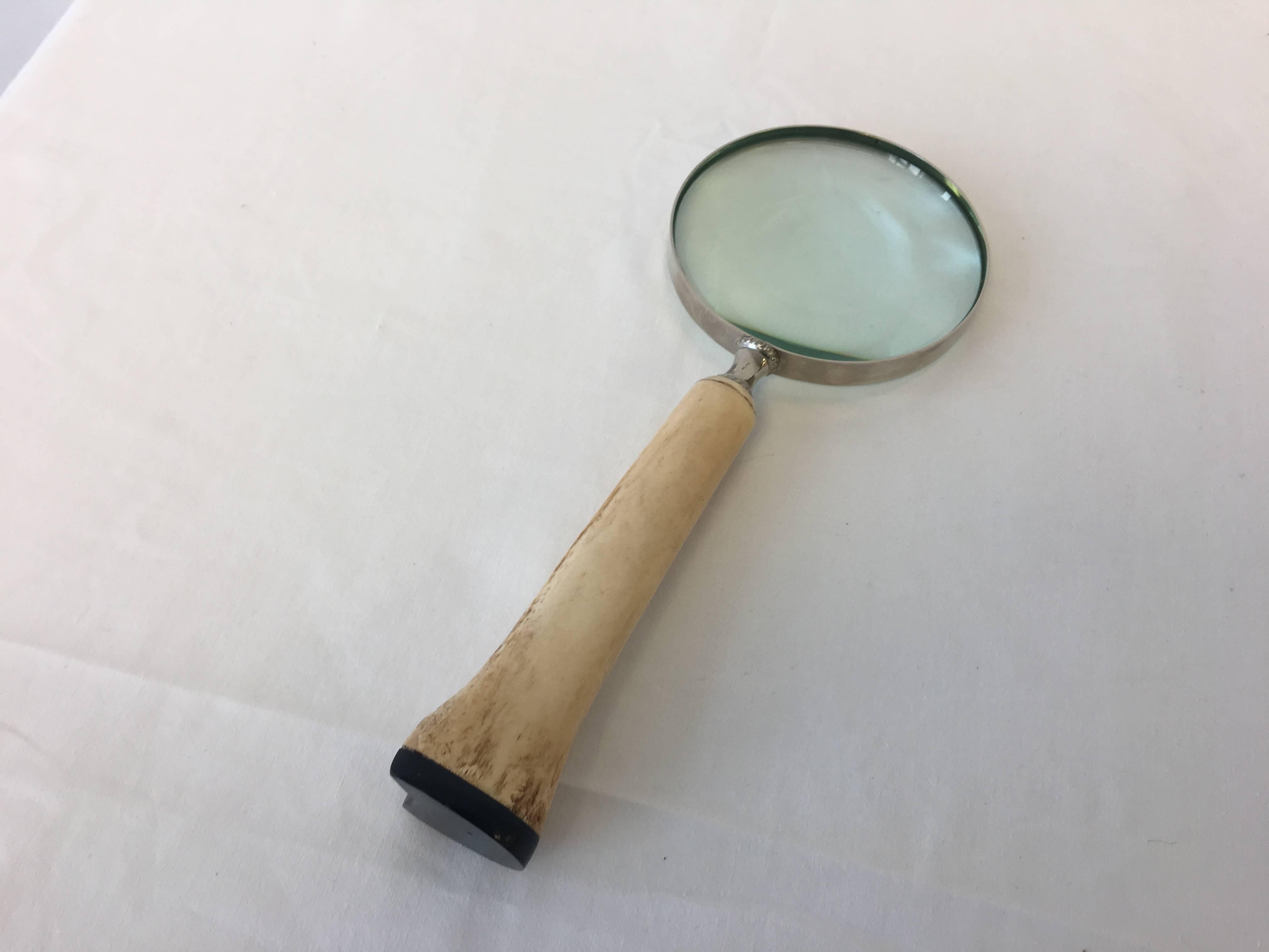 Offered is a stunning, white bone magnifying glass encased in sterling silver.
