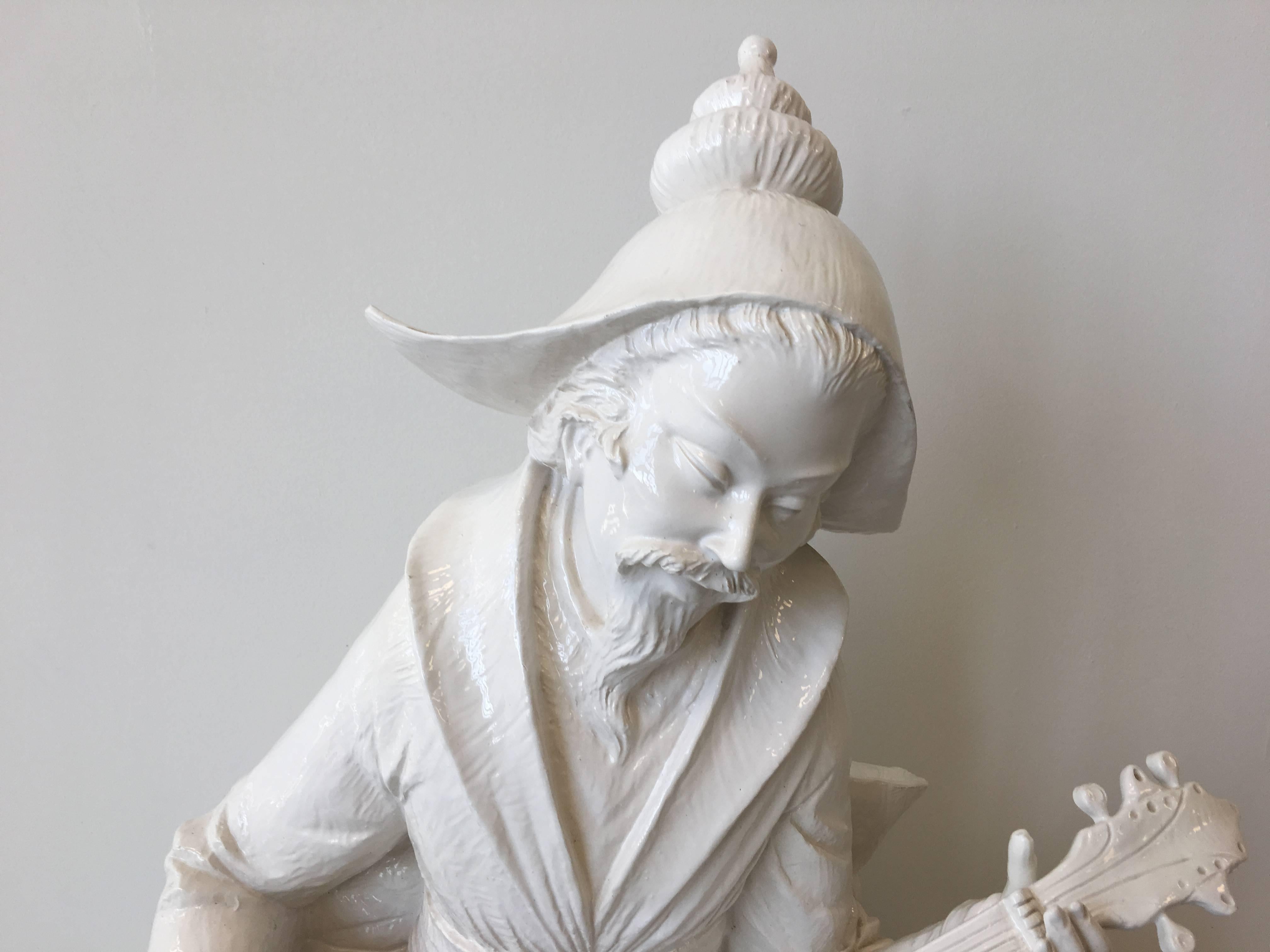 Offered is a substantial, 1960s Blanc de Chine male figure. He is gracefully sitting, playing the quinquin instrument (Asian mandolin). Immaculate detailing.