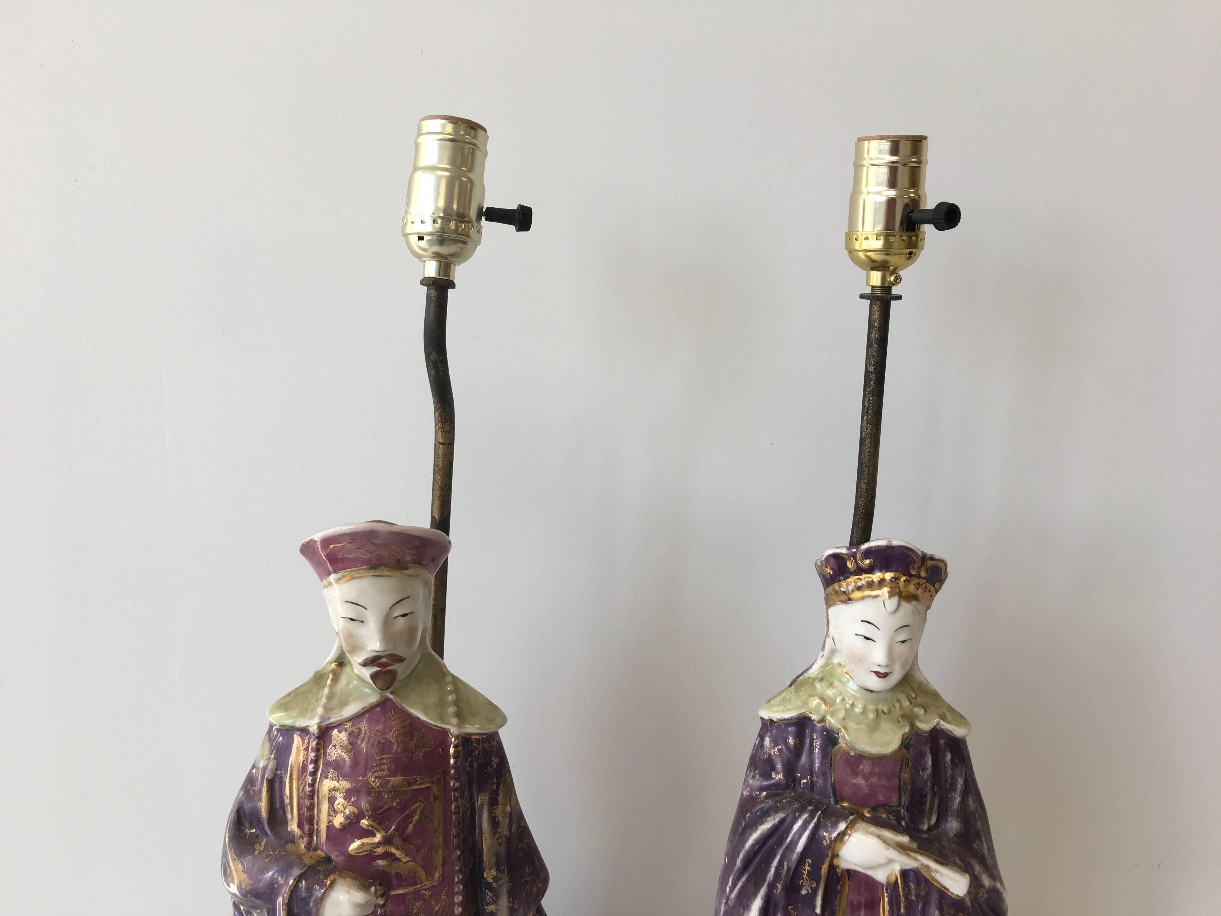 Offered is a stunning pair of 1920s, Asian emperor and empress figural statue lamps. Rested upon decorative bronze bases. Each figure features 18-karat gold accents. Newly rewired. Each figure measures 18
