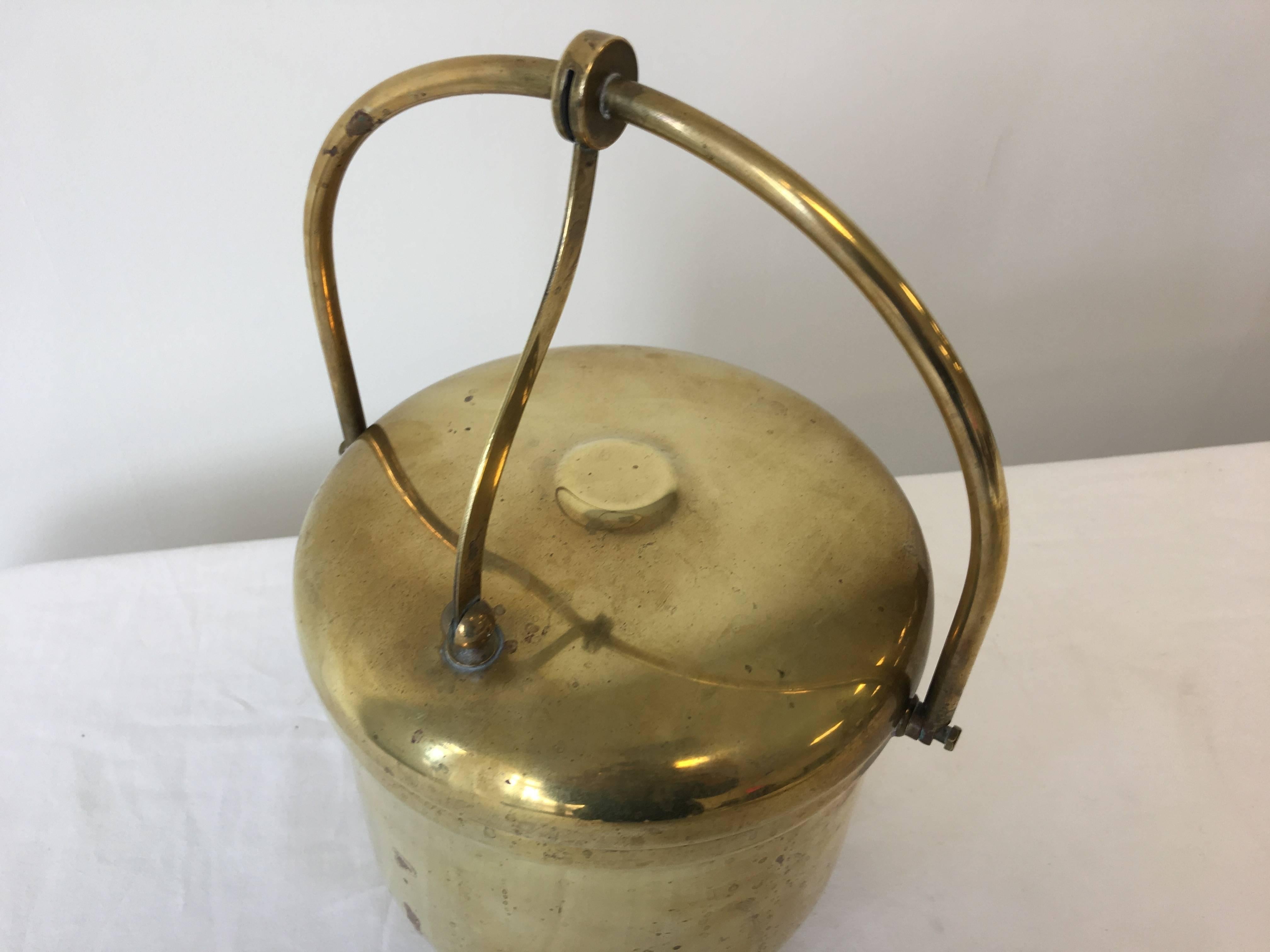 Offered is a beautiful, 1920s brass ice bucket with porcelain liner.