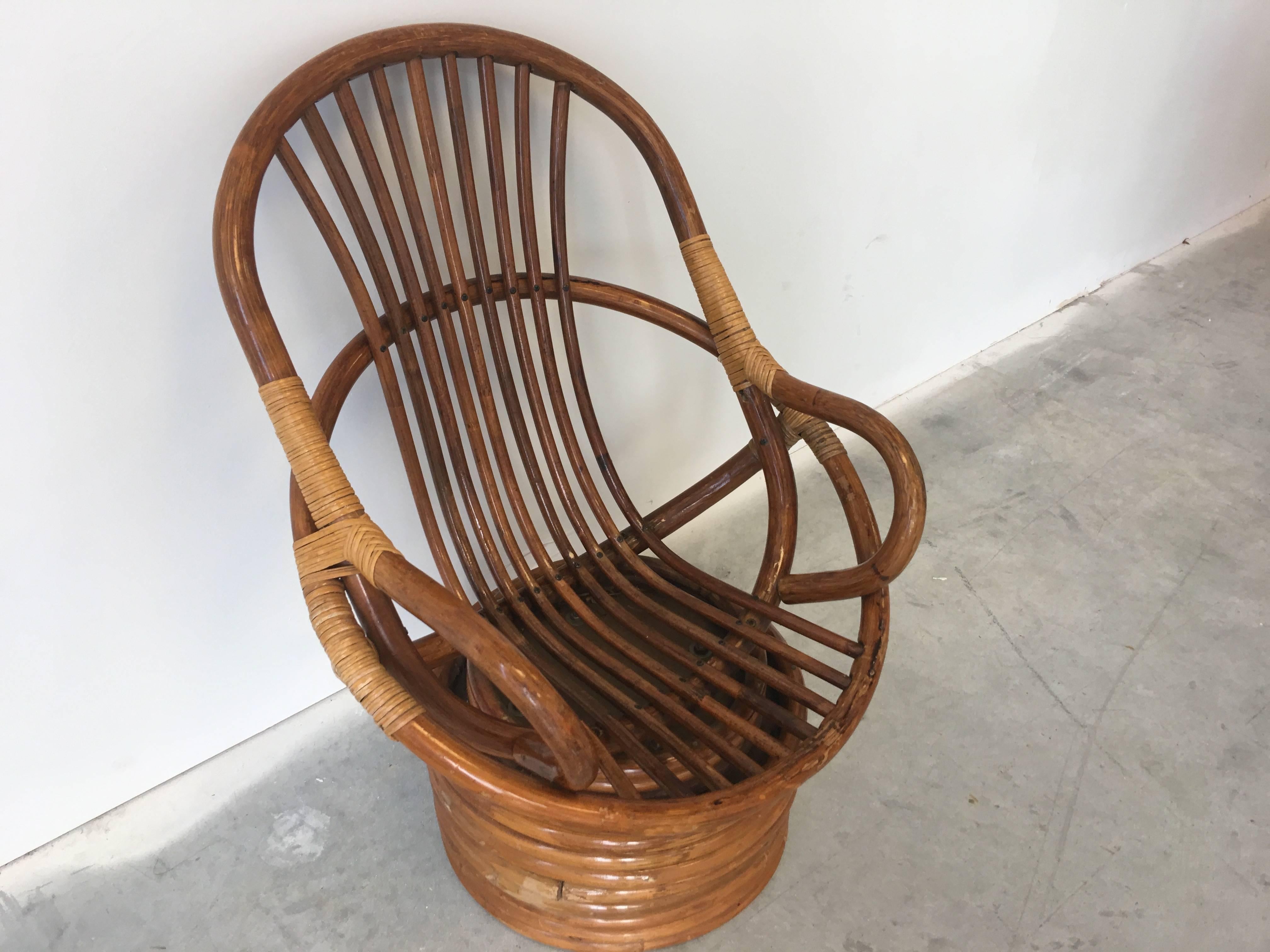 Offered is a beautiful, Palm Beach style 1950s children's rattan swivel chair.