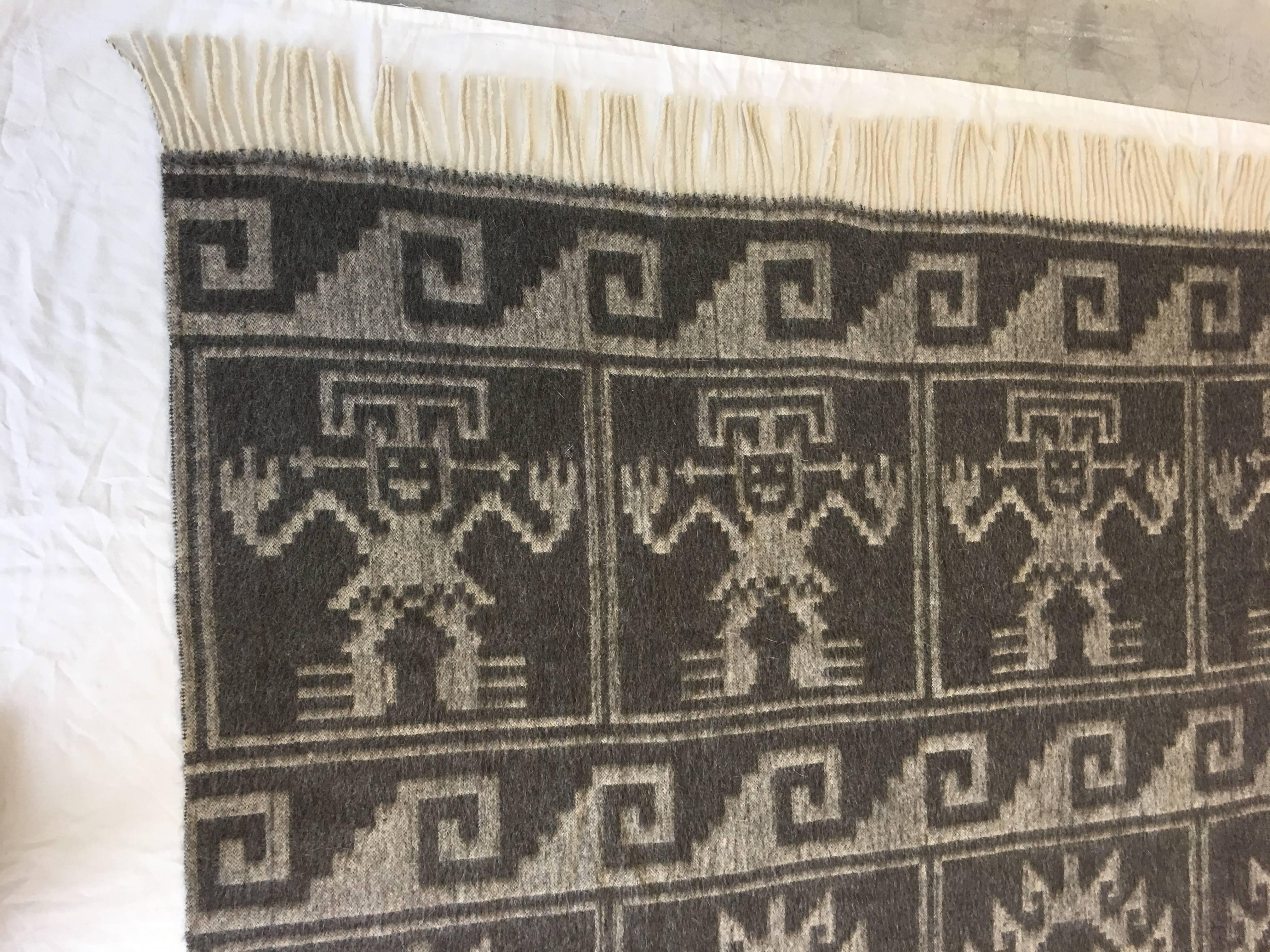 Offered is an absolutely gorgeous, 1950s Mid-Century, gray monochrome throw blanket with an Aztec god and sun design. Made of 100% alpaca wool.