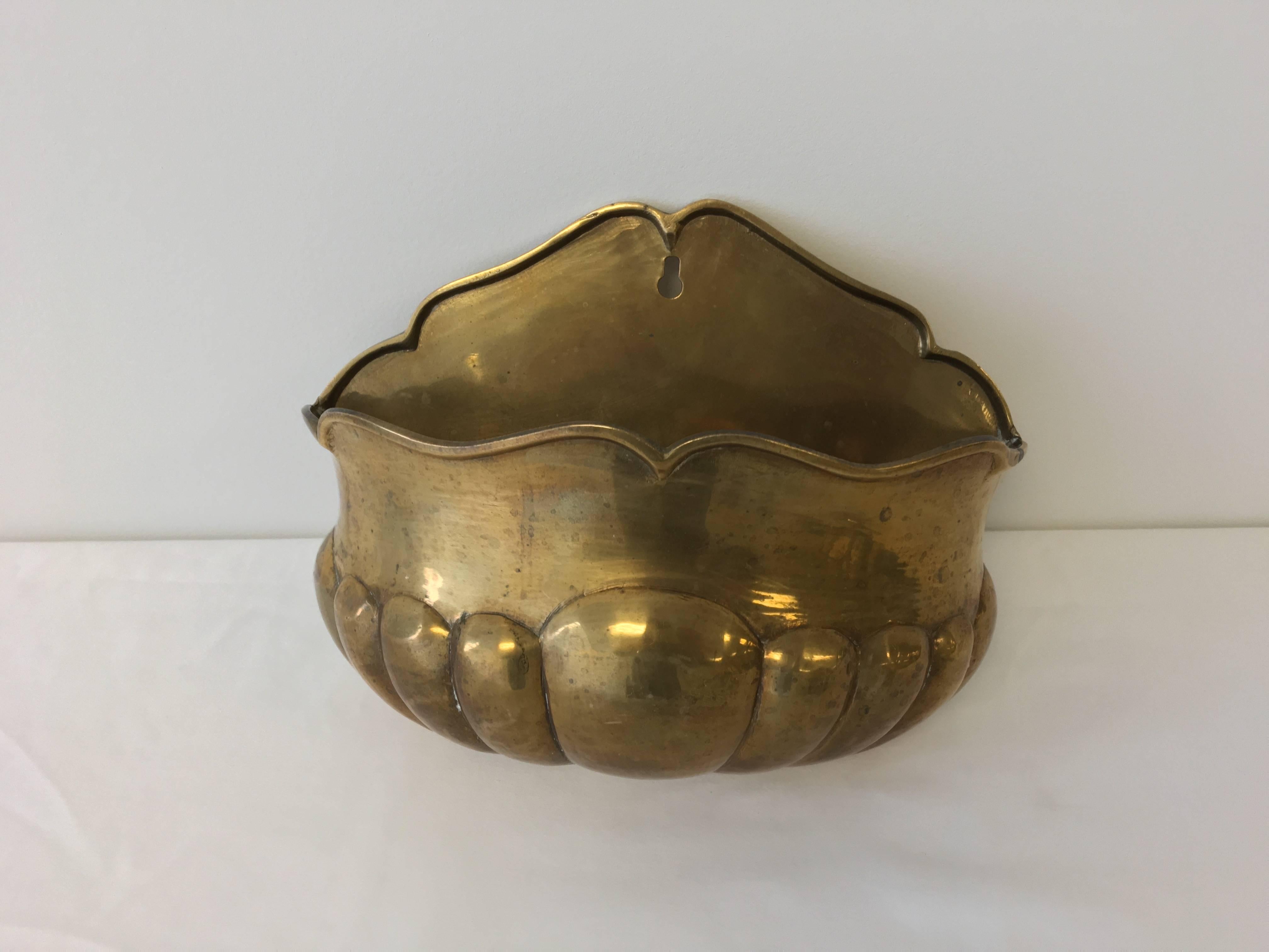 Offered is a beautiful, 1950s brass wall pocket. Substantial weight.