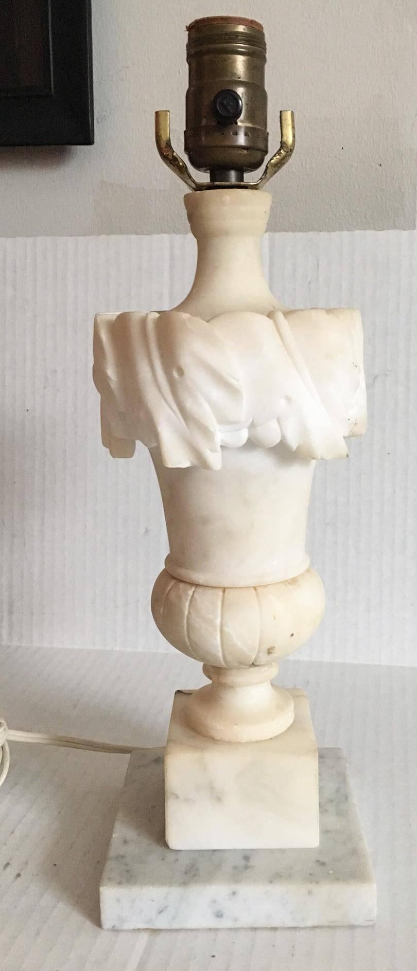 Offered is a stunning, 1930s, Italian, heavy solid carved alabaster lamp in the shape of a classical urn on a square marble base. Lamp retains its original finial as shown, and comes with the shown 8.5