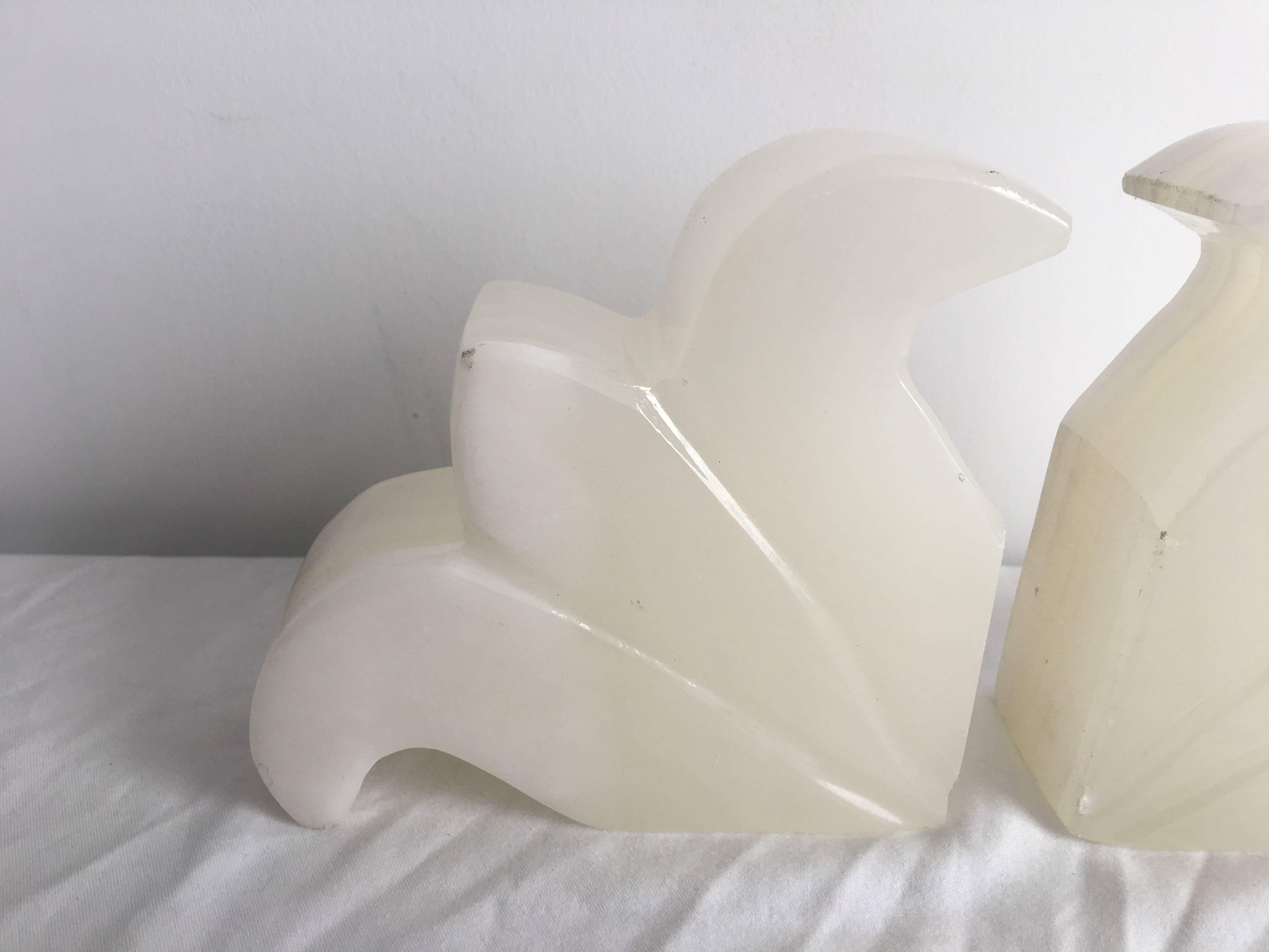Offered is a stunning, pair of 1920s Fleur de Lis, white onyx bookends.