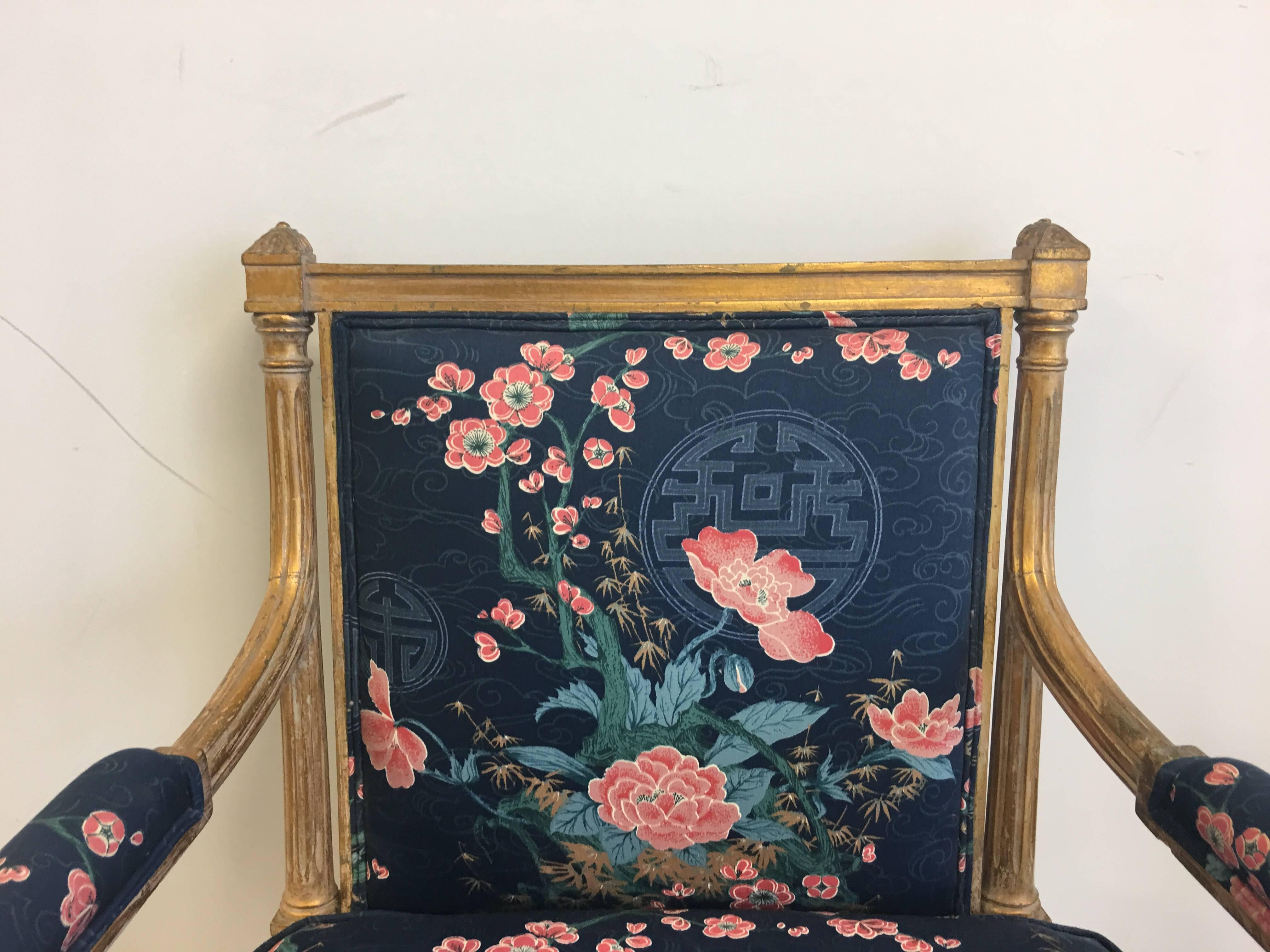 Offered is a gorgeous, 1950s chinoiserie gilt armchair. Upholstered in a navy thick-cotton blend fabric, with cherry blossom motif and ornate medallions. Extremely sturdy.