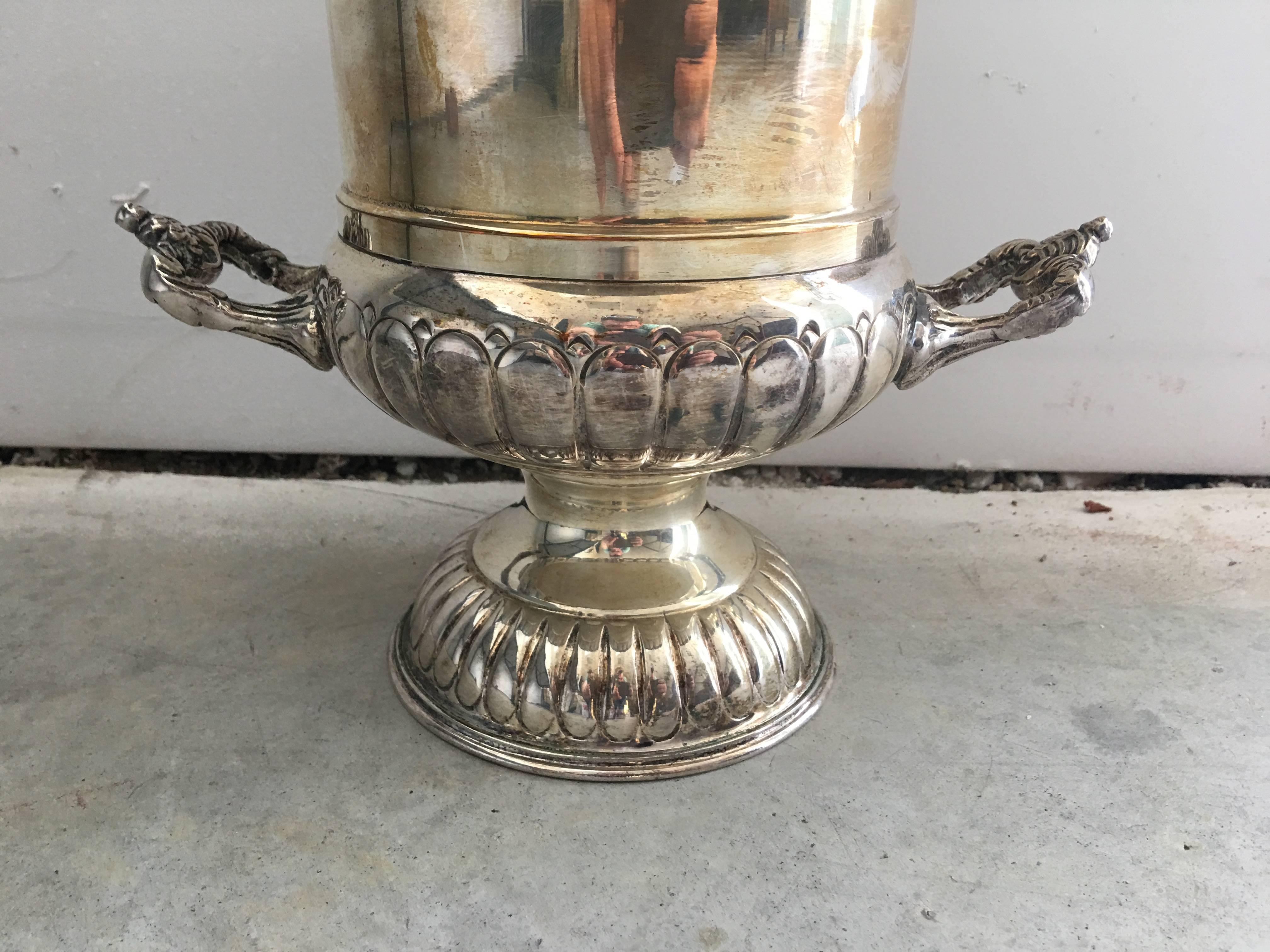 Offered is a stunning, 1930s English silver plated urn wine chiller. Stamped, "Made in England." Removable liner. Can be used for floral arrangements as well.
 