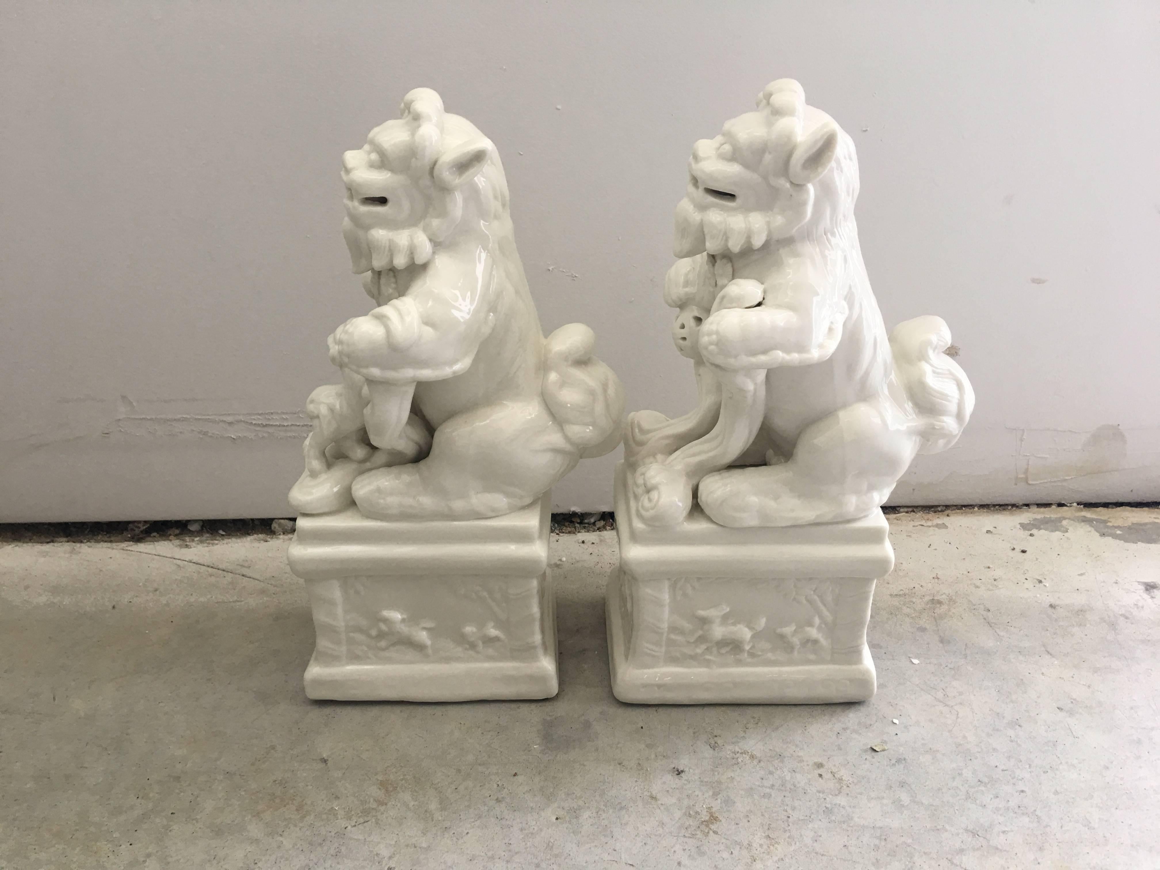 Offered is a gorgeous, pair of 1960s Blanc de Chine foo dog statues, rested on pedestals. Would make lovely bookends.