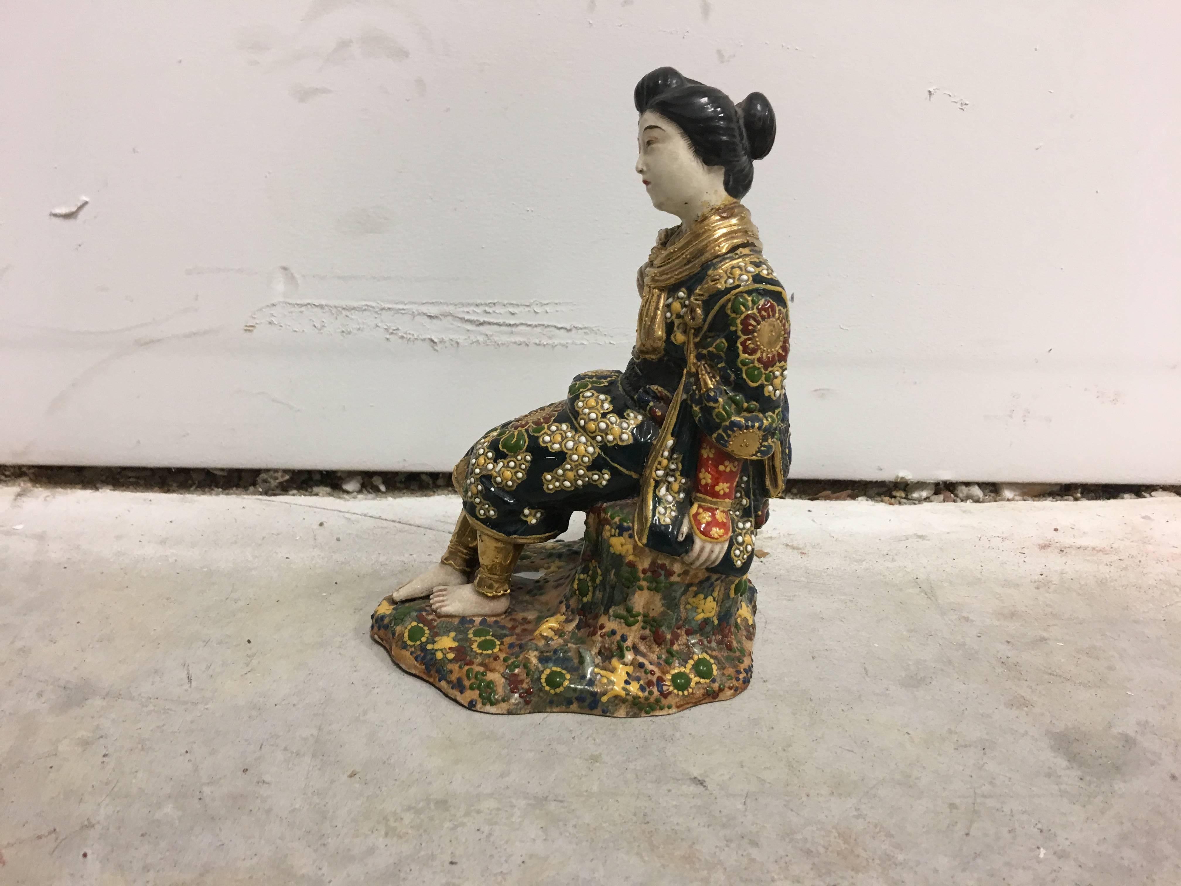 Offered is a stunning, 1960s Asian geisha polychrome ceramic statue with gold accents.