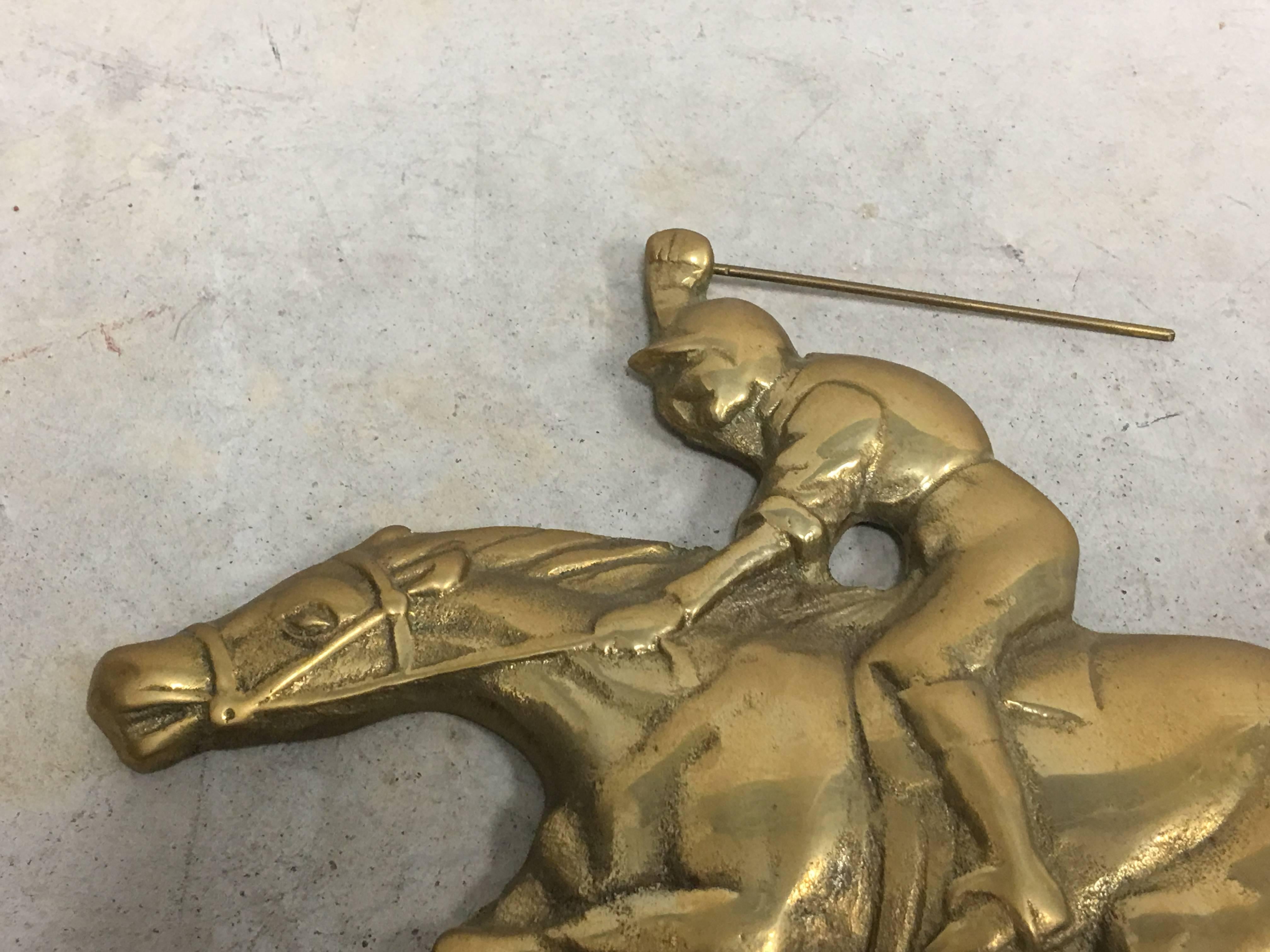 Offered is a beautiful, 1960s horse jockey and horse solid-brass wall plaque sculpture. Has a small hook on backside for hanging.