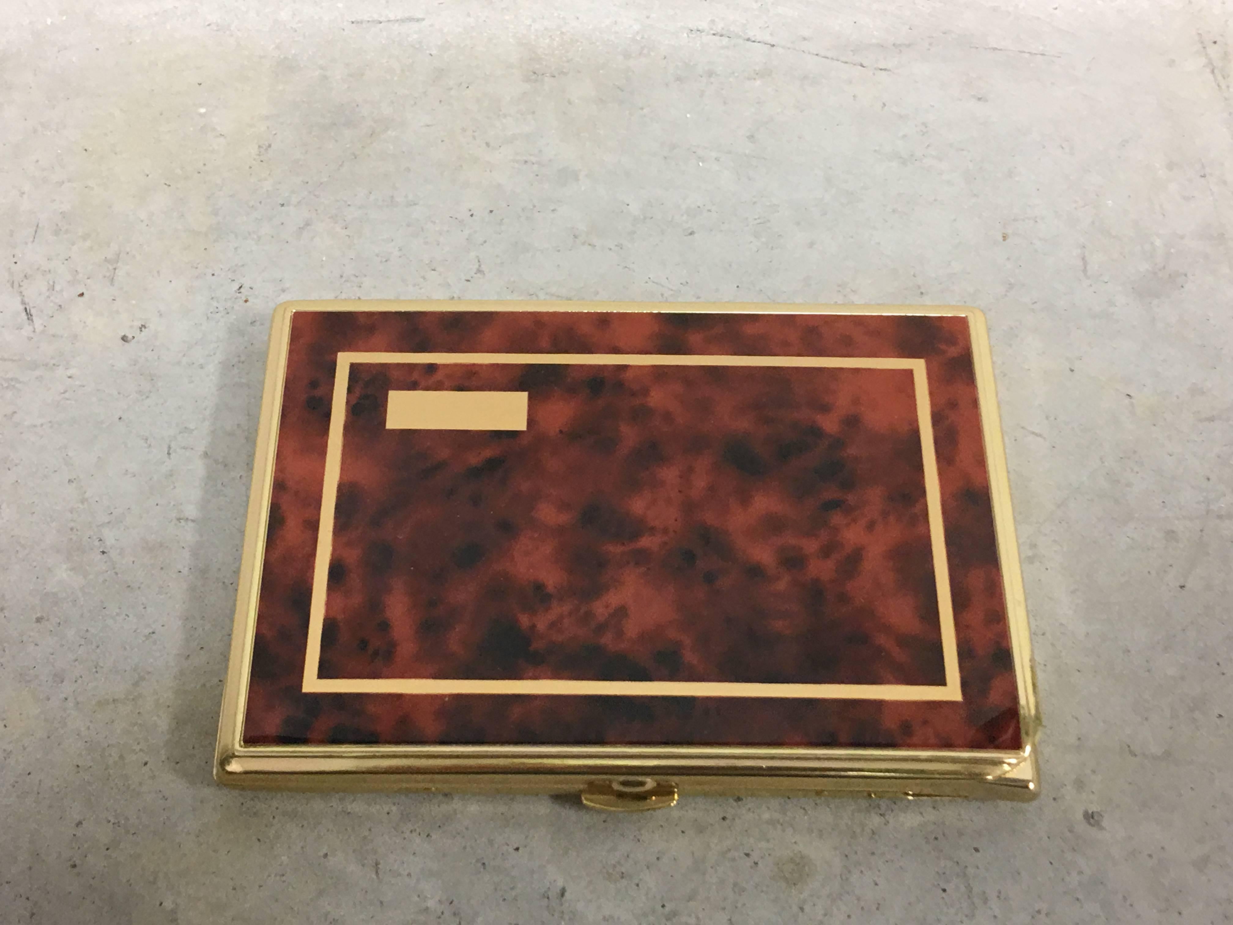 Offered is a beautiful, 1960s burl wood veneer and brass cigarette case with built-in lighter. Not monogrammed. Never used.