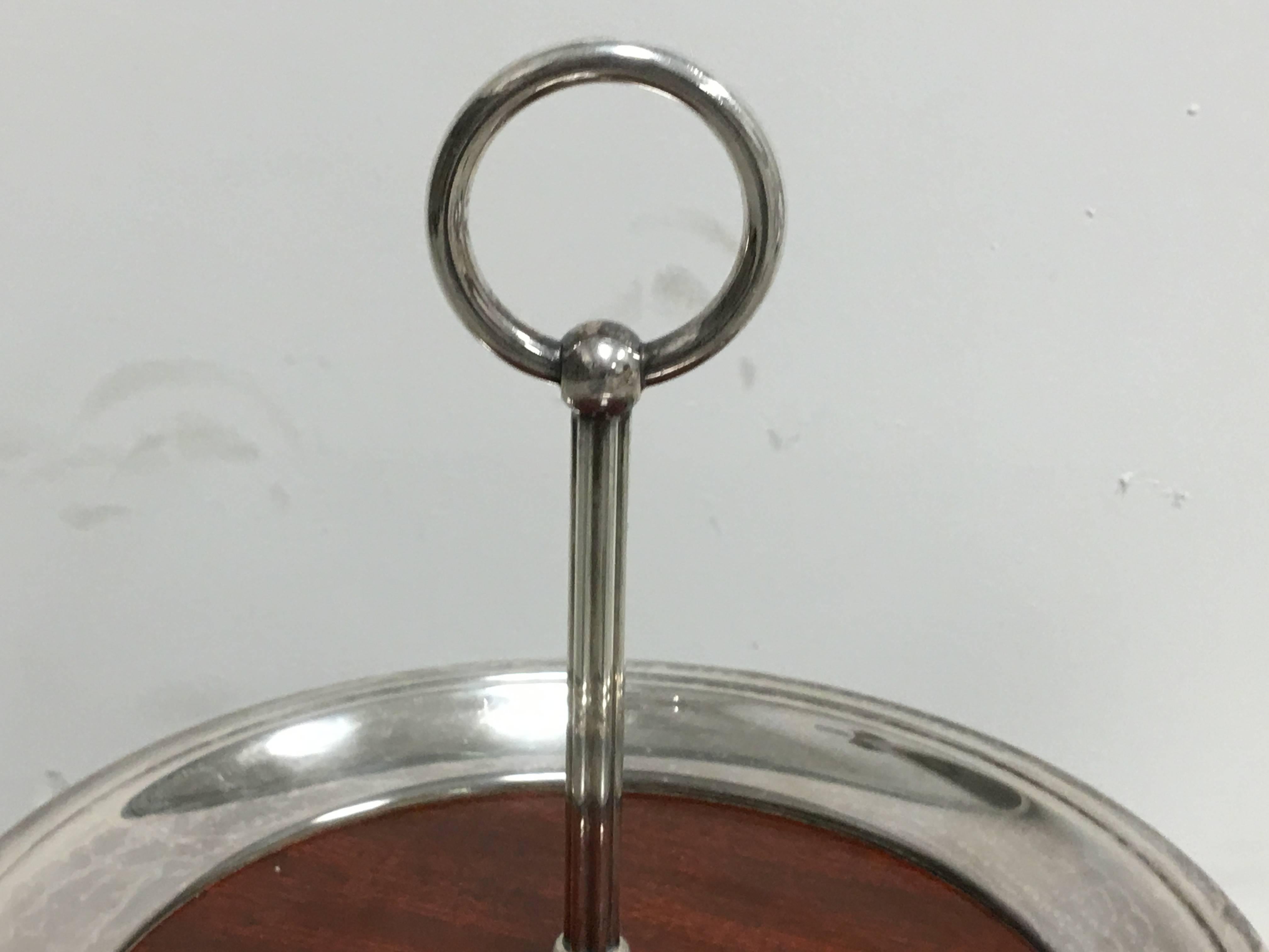 Offered is a beautiful, 1950s, Mid-Century Modern, two-tiered silver plate and mahogany veneer server with handle.