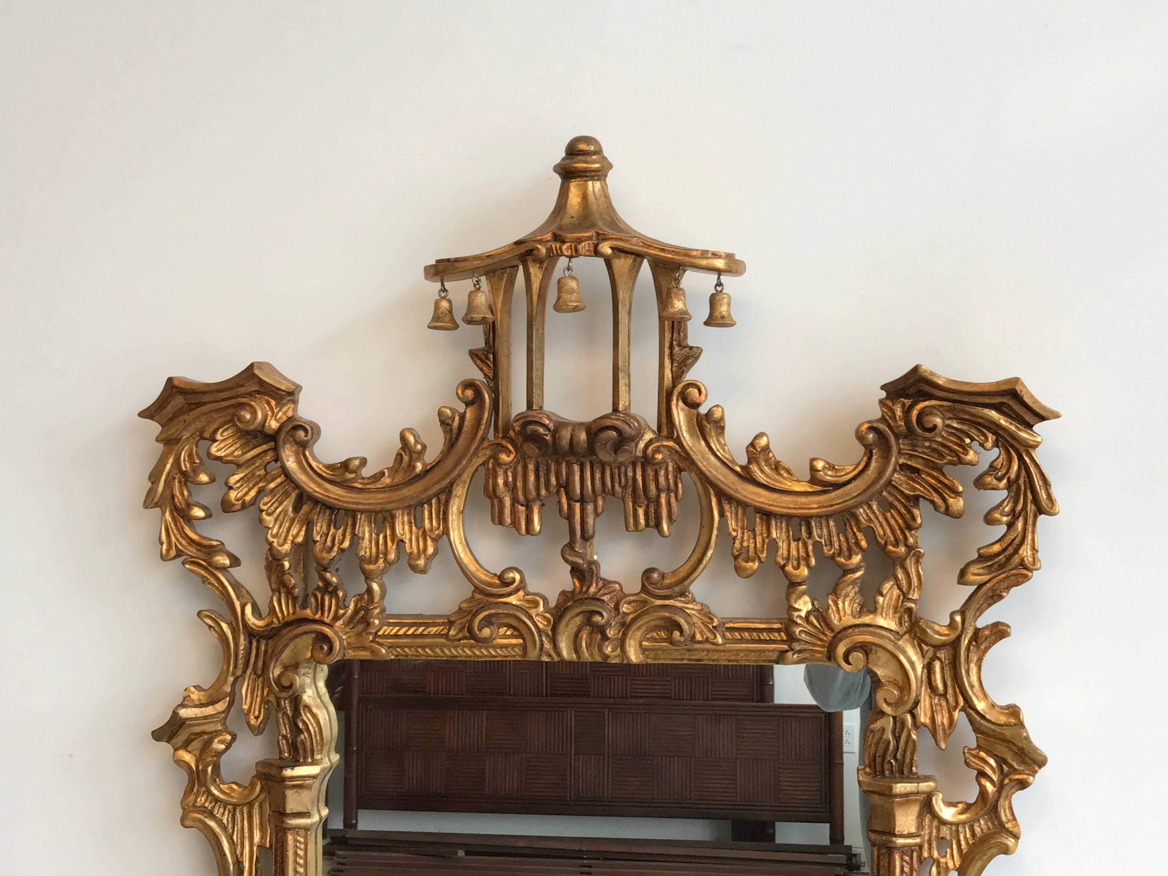 Offered is a gorgeous, substantial 1970s giltwood pagoda mirror. The piece has stunning detailing, with ornate crests and carvings. Solid wood.